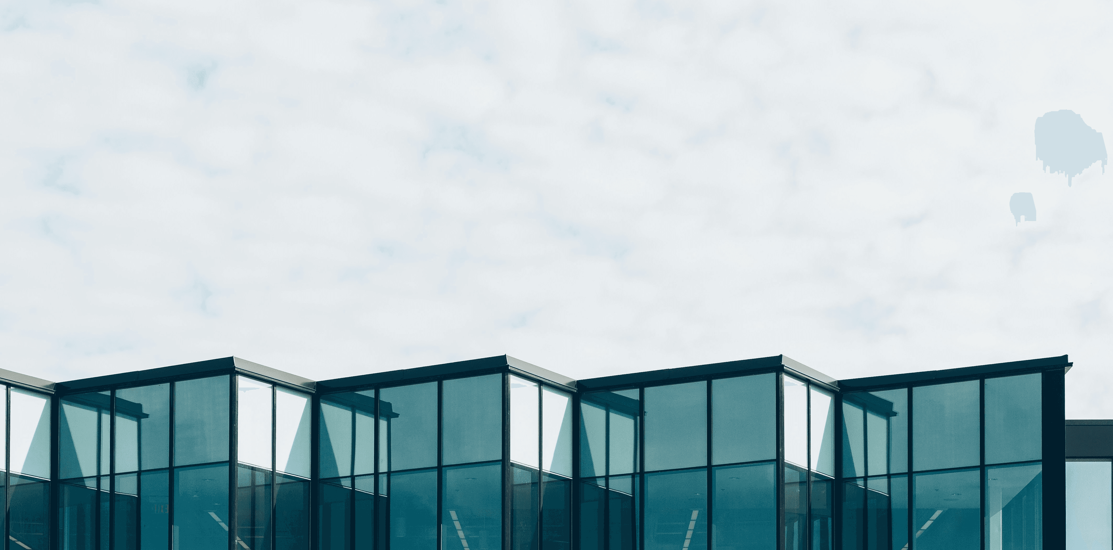 curtain wall building under cloud formation during daytime