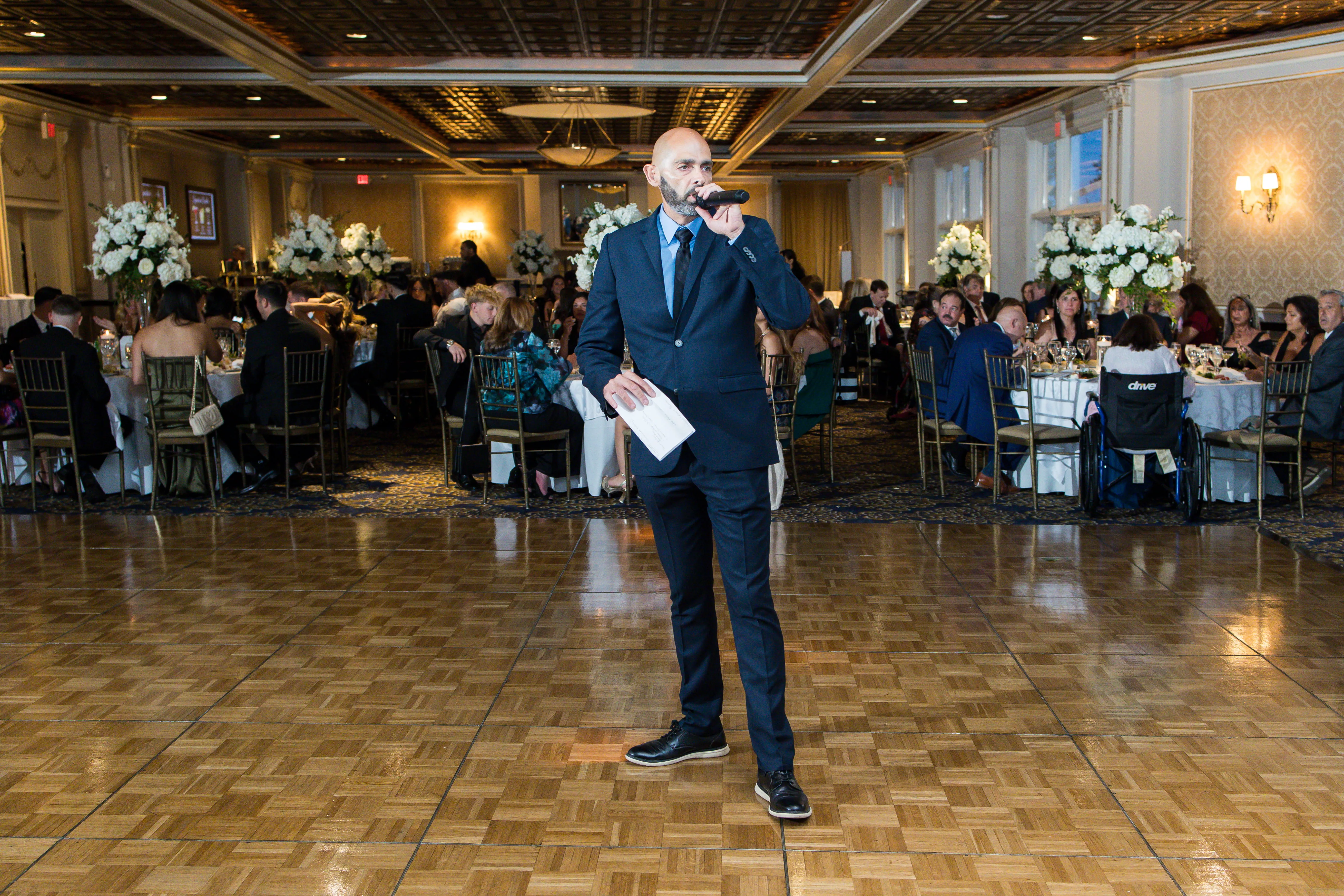Wedding MC speaking to guests at VIP Country Club ballroom reception in Westchester