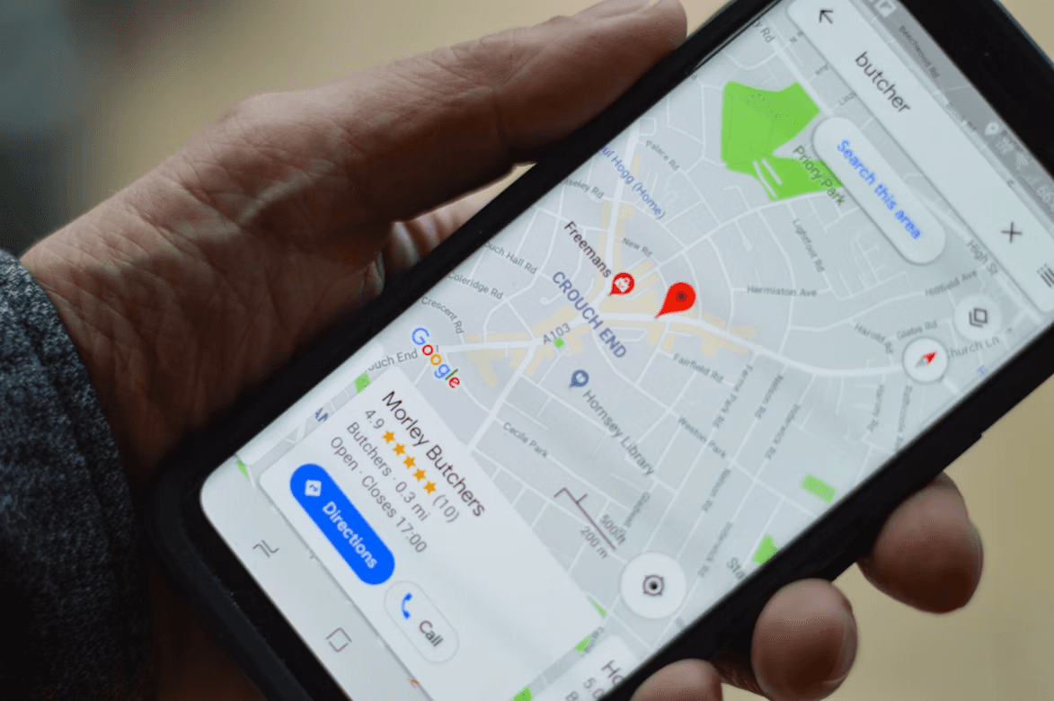 Personne tenant un smartphone affichant Google Maps avec une localisation marquée