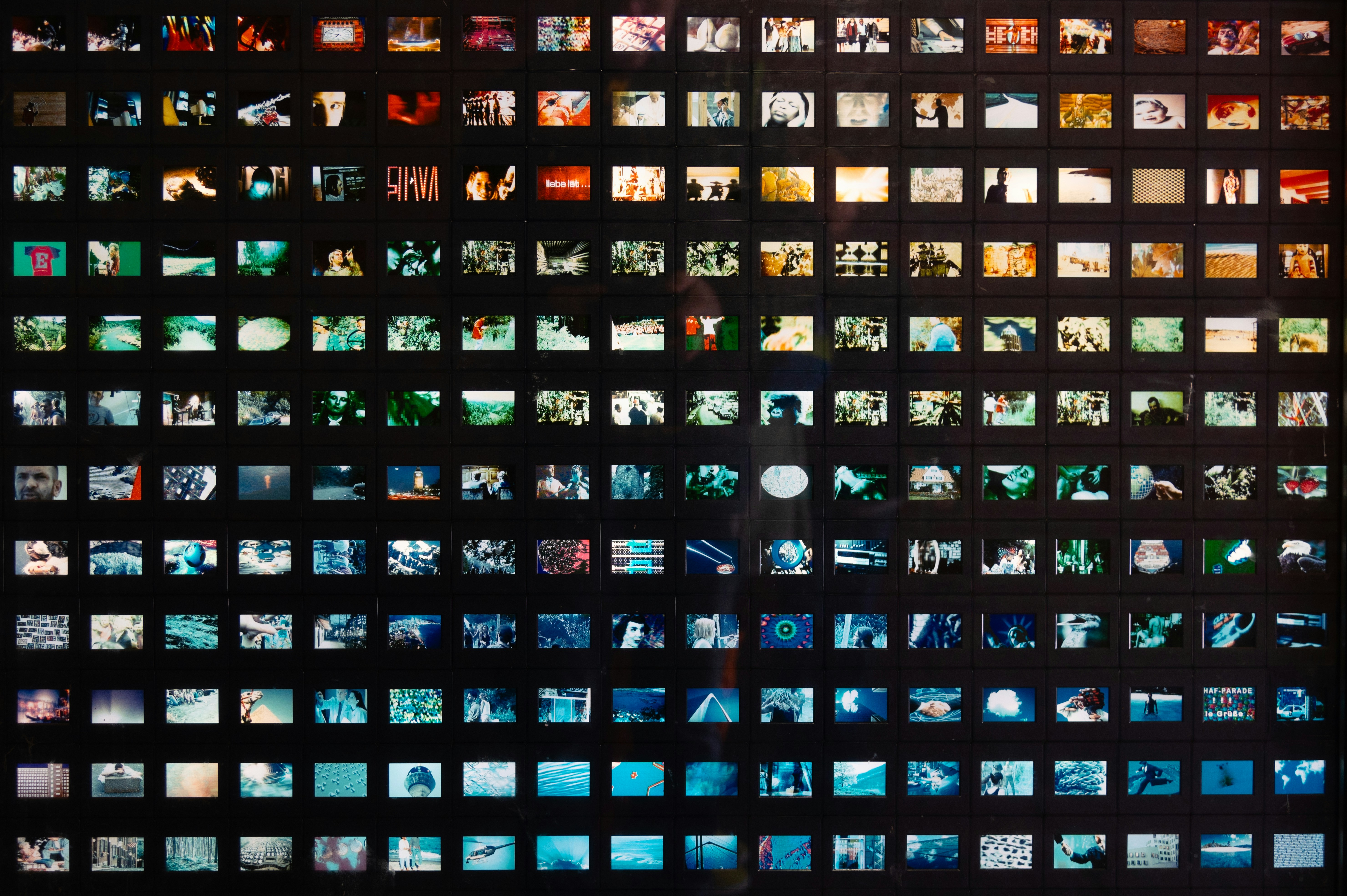 Desk with computer displaying a densely organized photo collection.