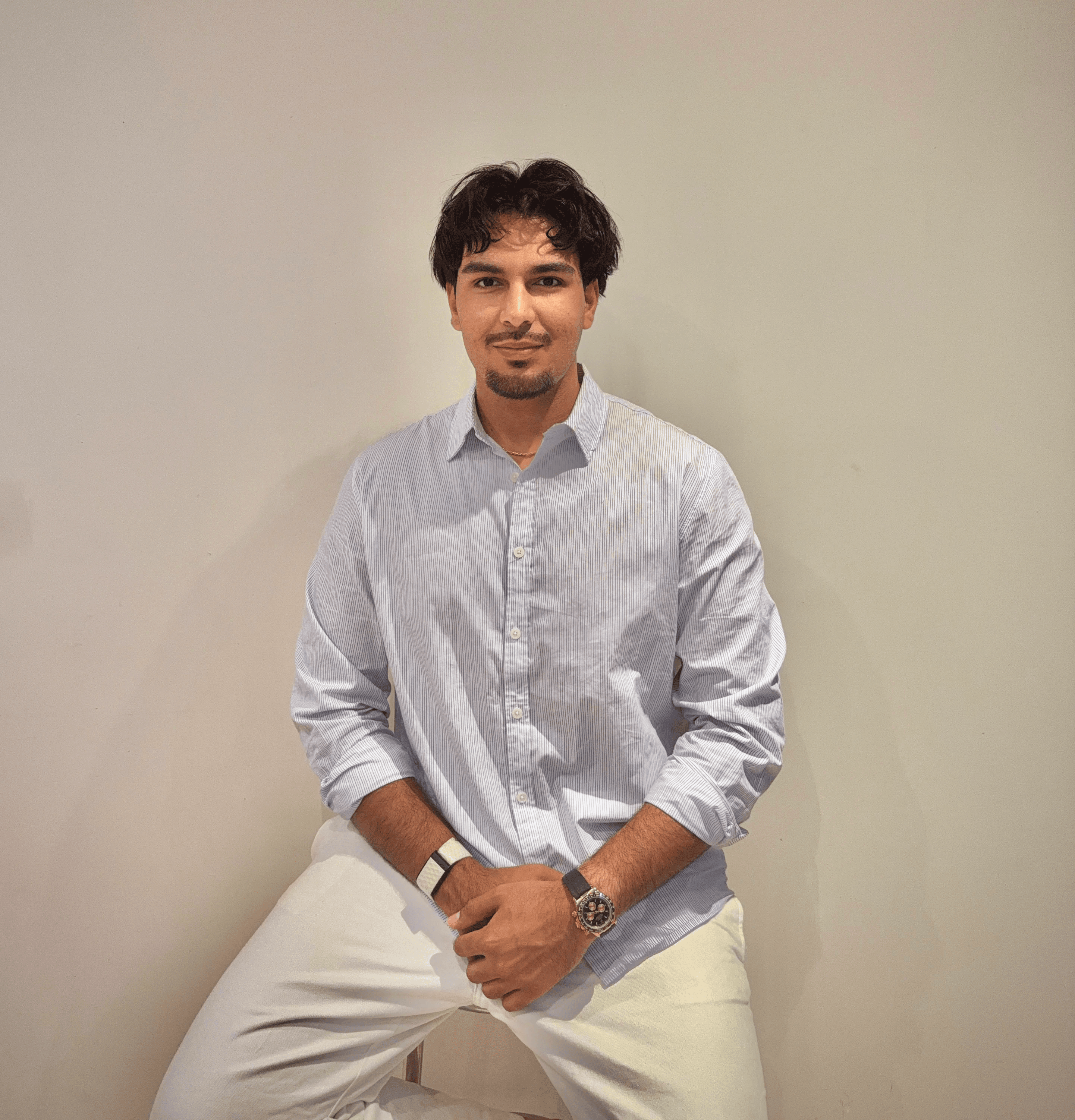 Portrait of a person in dark clothing speaking on a phone