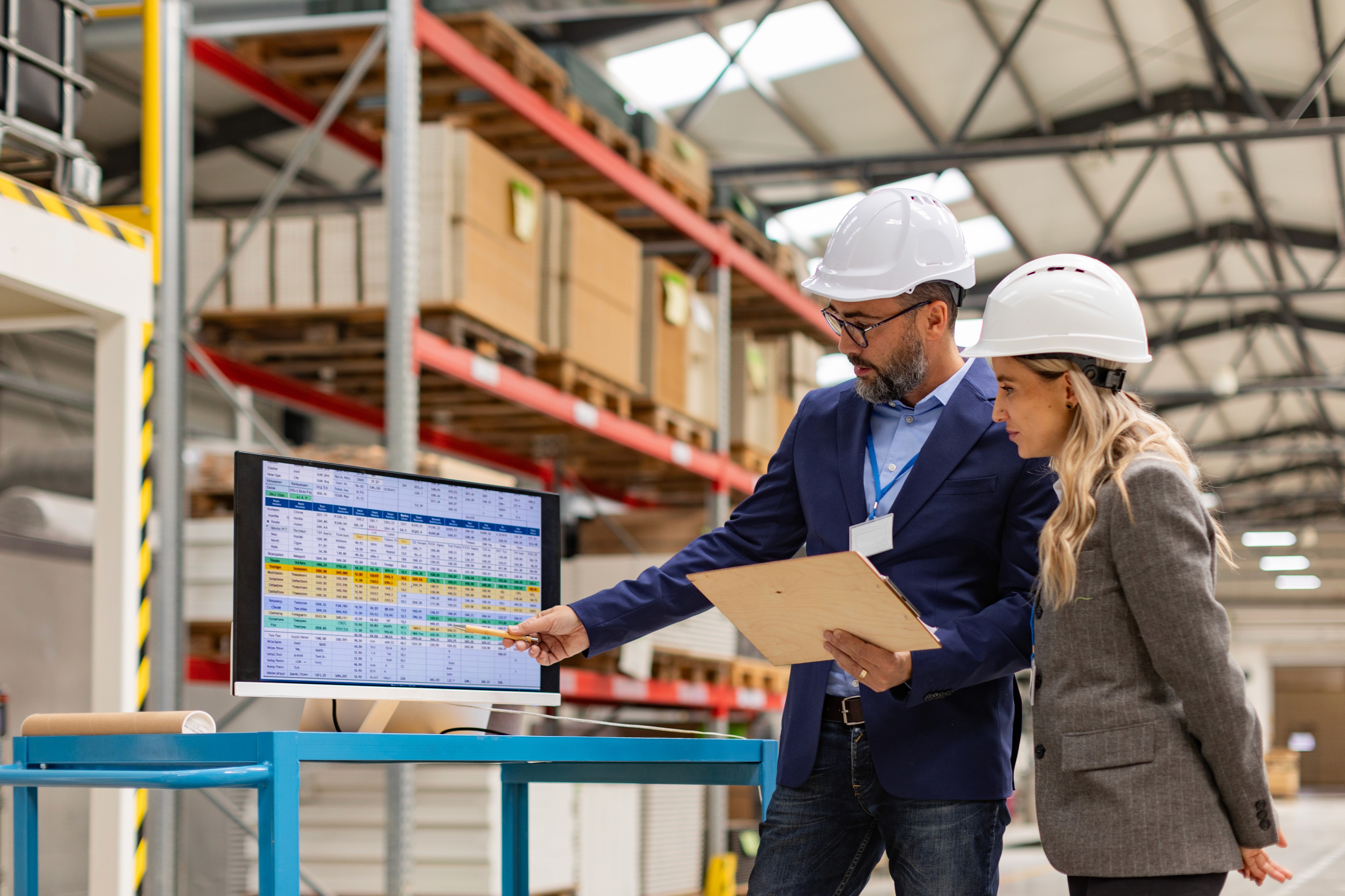 Manufacturing professionals reviewing commercial and operational data, representing manufacturing marketing and digital marketing for manufacturers.