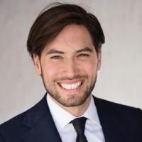 smiling woman wearing white and black pinstriped collared top