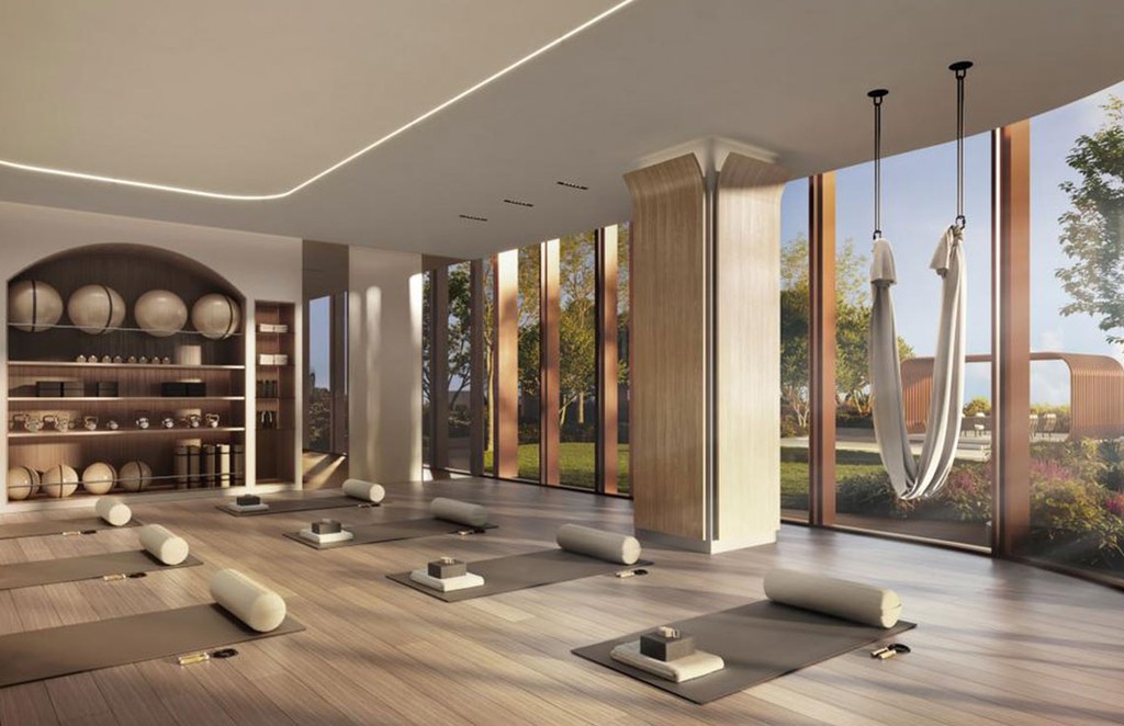 The lobby of 31 Above by Beyond showcases a stylish design with gold and white decor, exuding elegance.