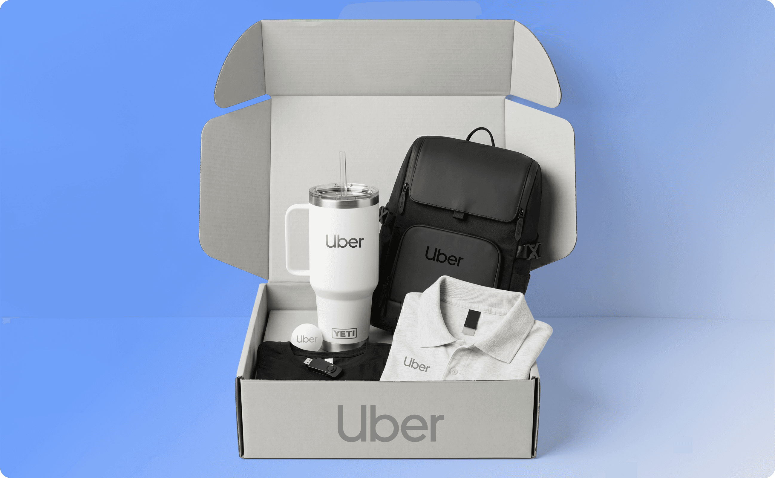 Uber's new hire kit, with tumbler, backpack, and polo shirt.