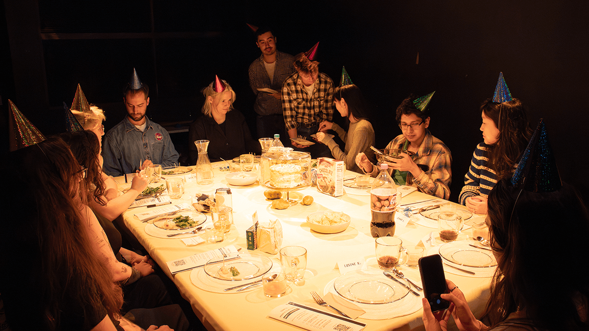 A larger dinner table where all the guests wear party hats.