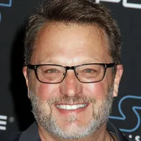 Steve Blum smilnig in front of a Star Wars background