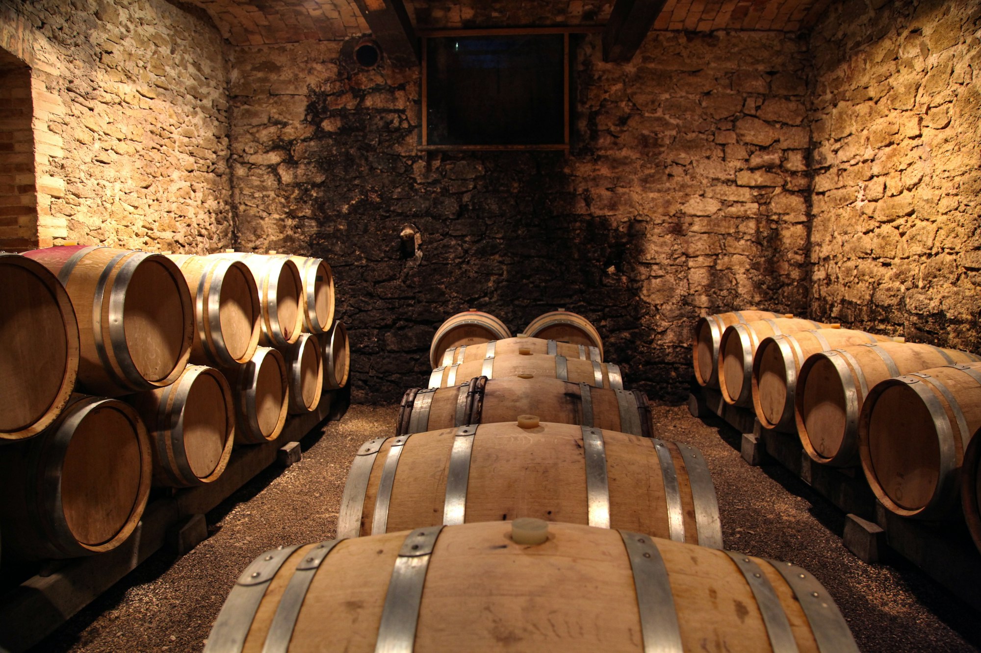 Oak barrels in a small stone cellar
