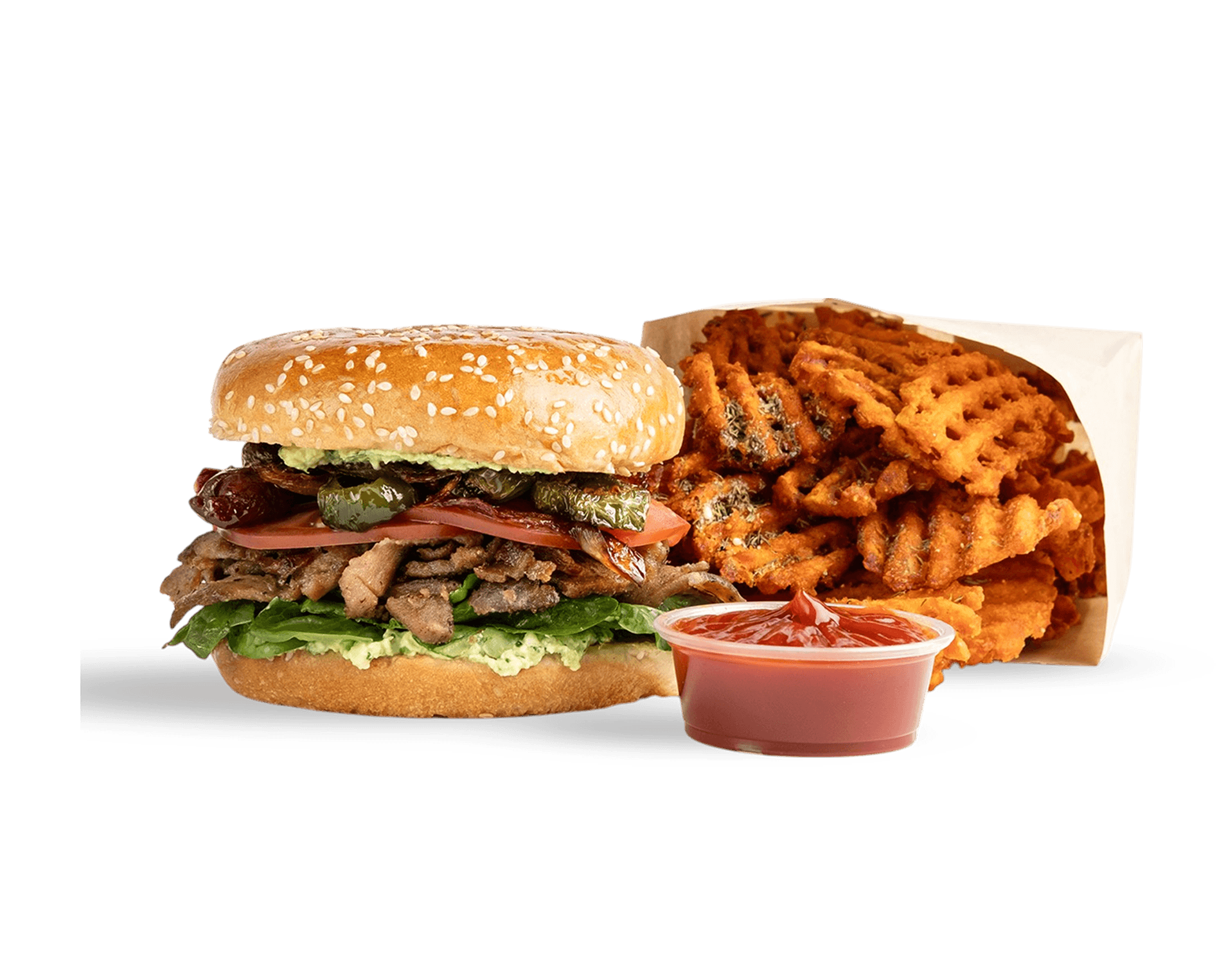 A toasted sandwich layered with Mediterranean meats, tomatoes, pickles, and fresh greens. With a side of waffel cut sweet potato fries and a small container of ketchup