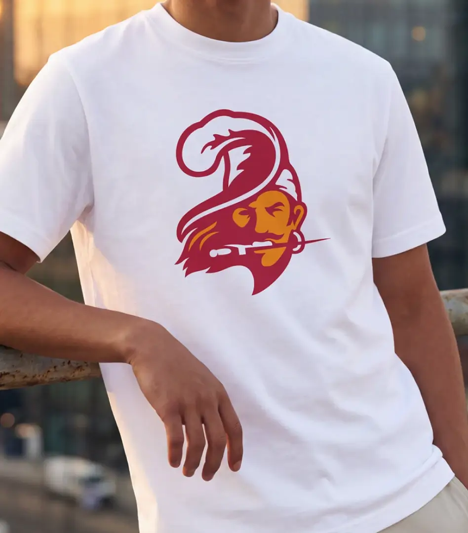 White t-shirt mockup featuring the redesigned Tampa Bay Buccaneers pirate head logo in maroon and gold.