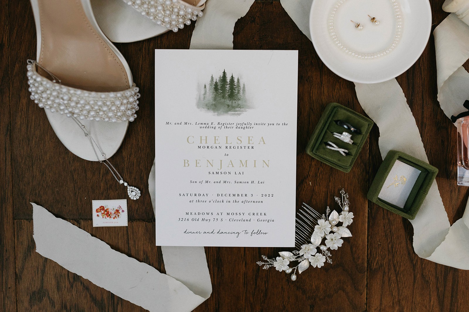 Guest seating chart framed by pine, pinecones, and greenery at Meadows of Mossy Creek in Atlanta, GA.