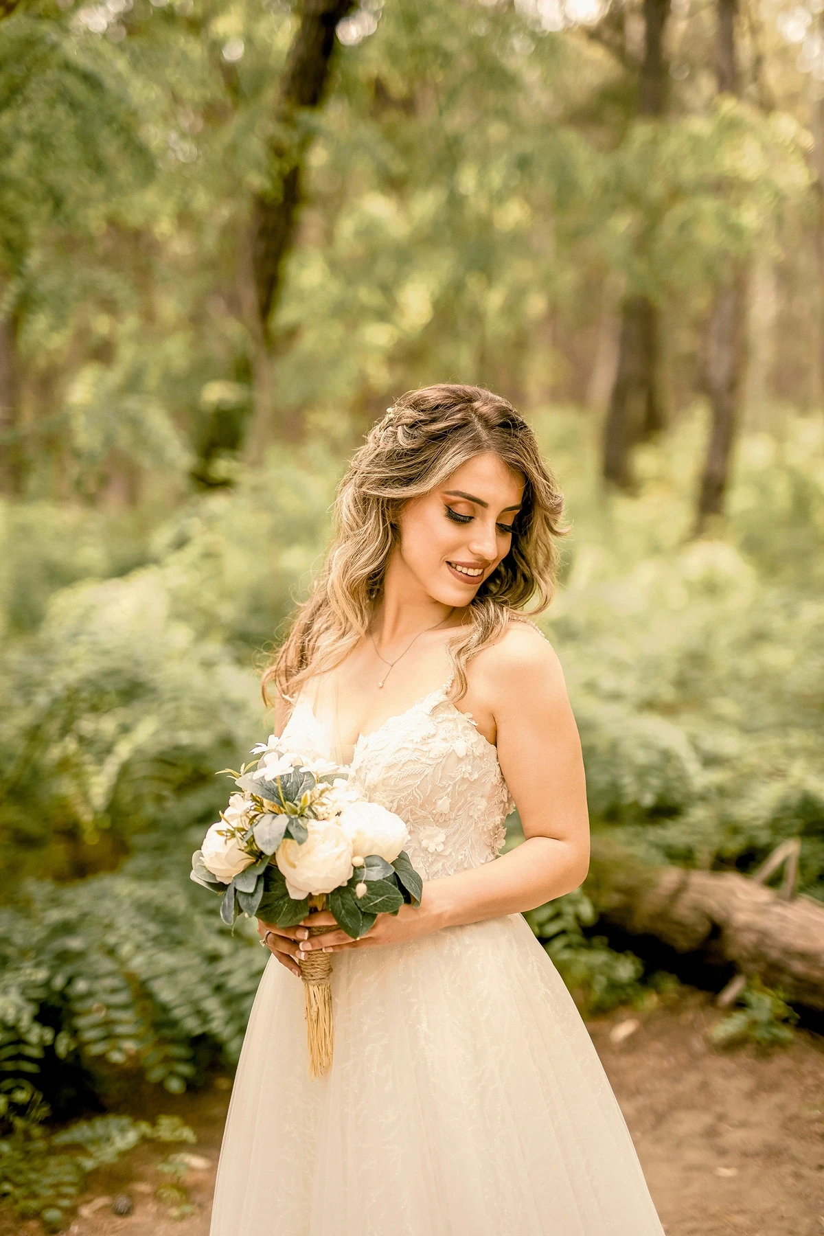 Bride holding a bouquet during an outdoor wedding photoshoot