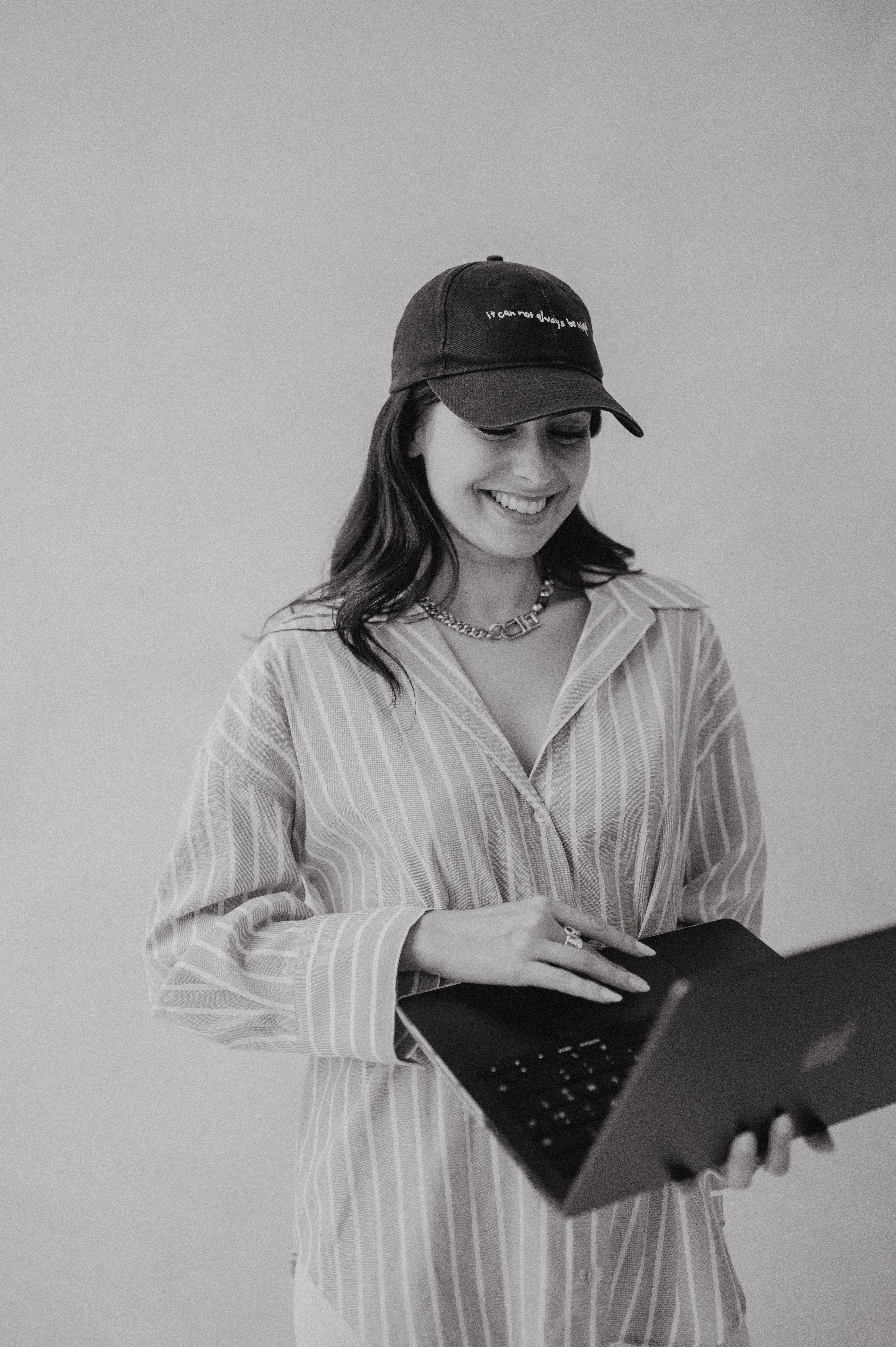 A close-up of a beige-colored laptop with a smooth, matte finish on a matching surface.