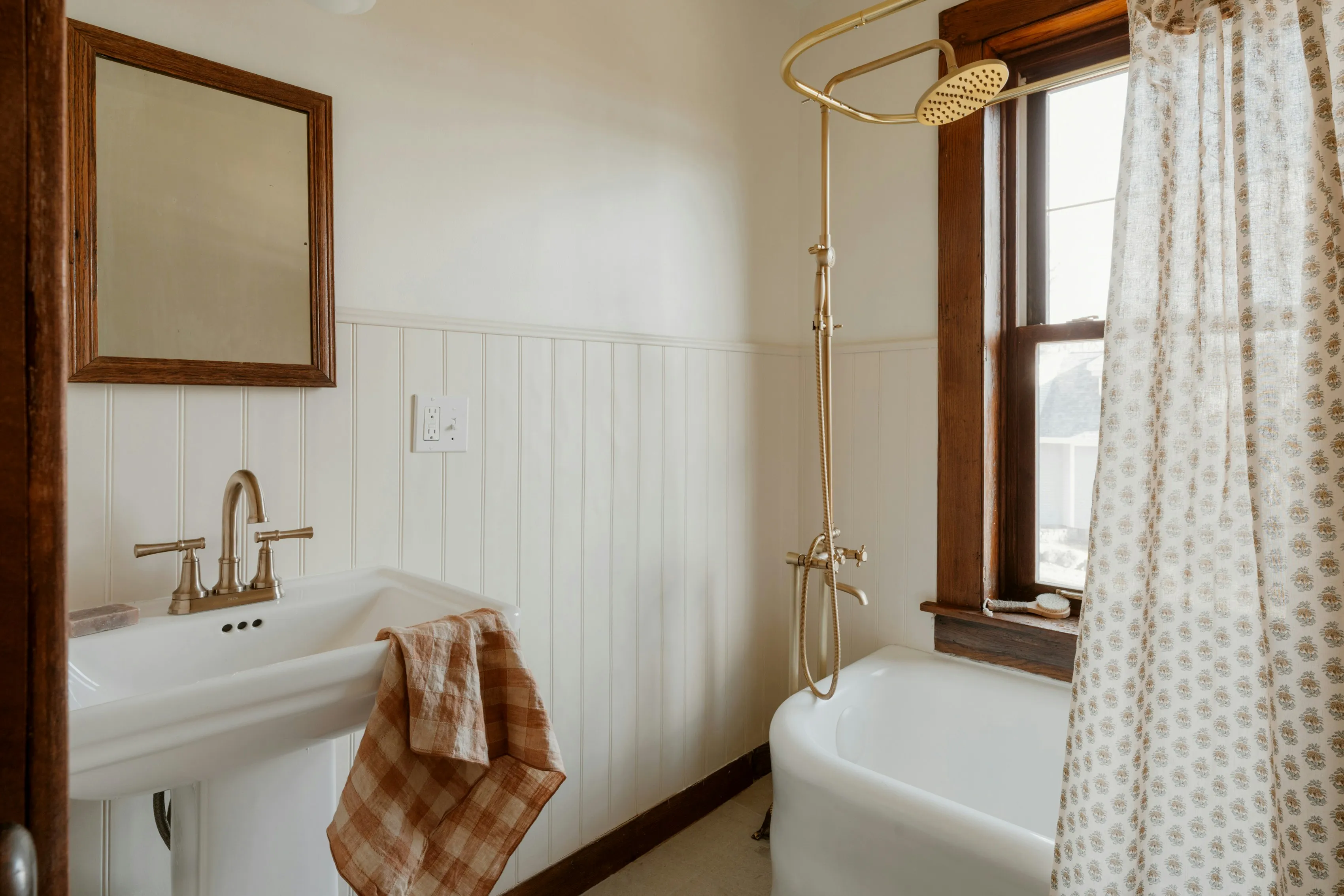 A vintage bathroom with a clawfoot tub and sink.
