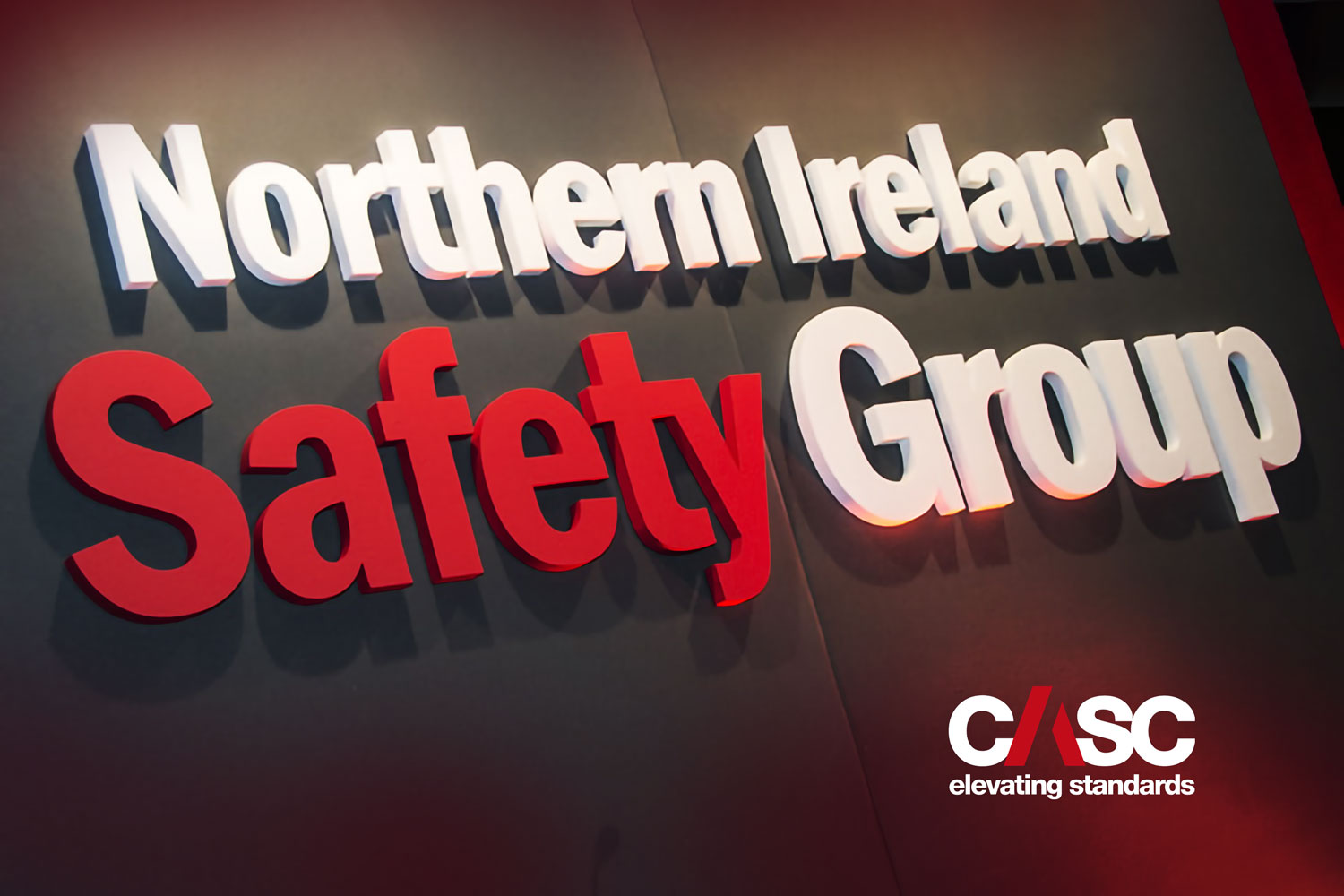 Interior wall signage reading ‘Northern Ireland Safety Group’ with CASC branding.