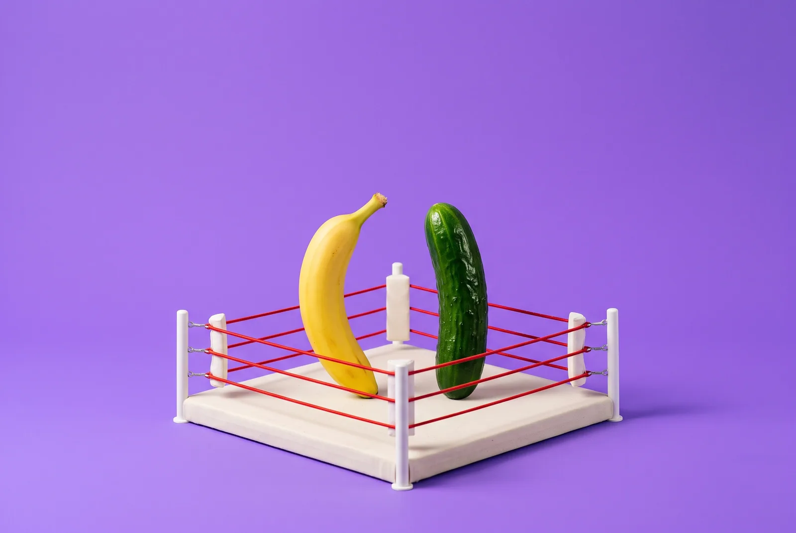 A banana and a cucumber facing off in a tiny boxing ring, a playful QUITTR vs Fortify comparison