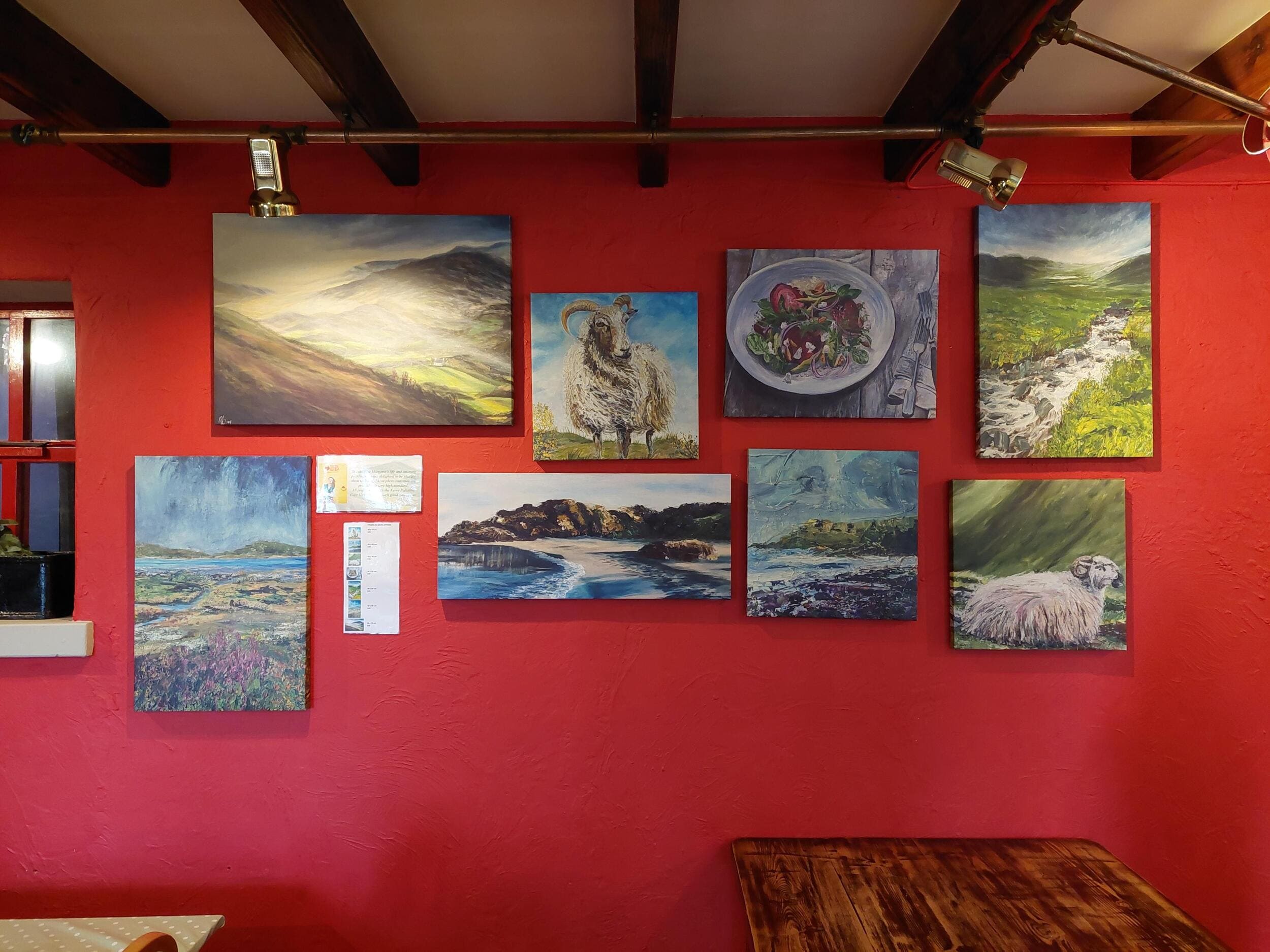 Photo canvases of Margaret's paintings on wall