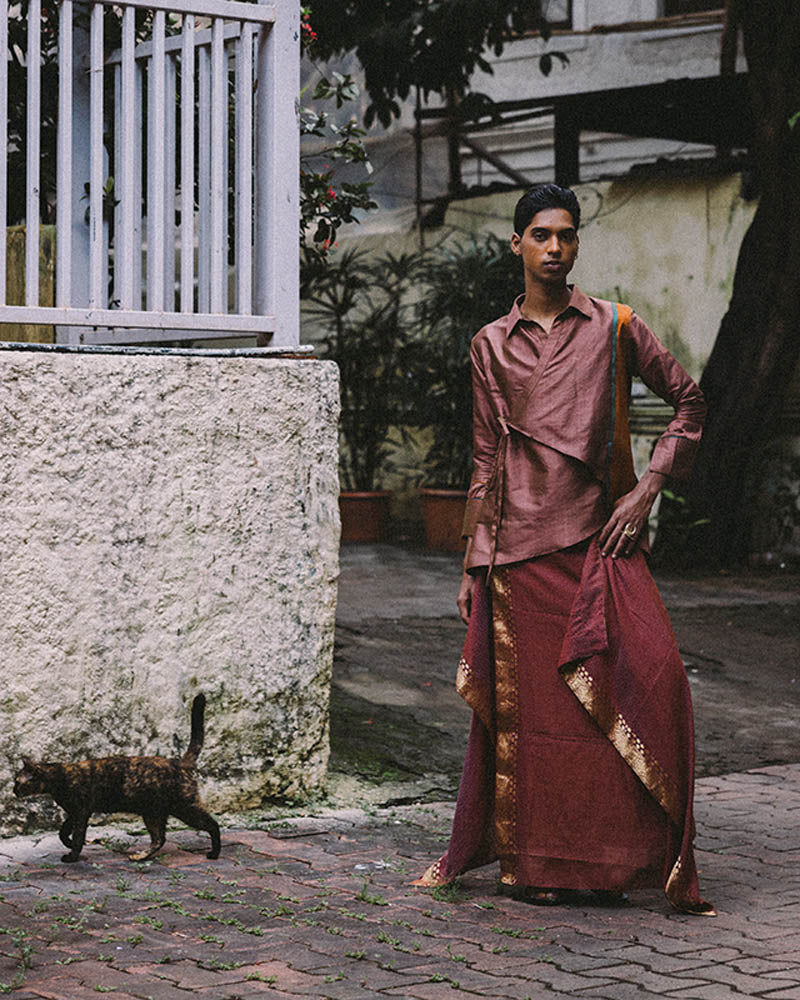 Vastram asymmetrical tunic with patch sleeves paired with Pancha drape skirt featuring bordered hem.