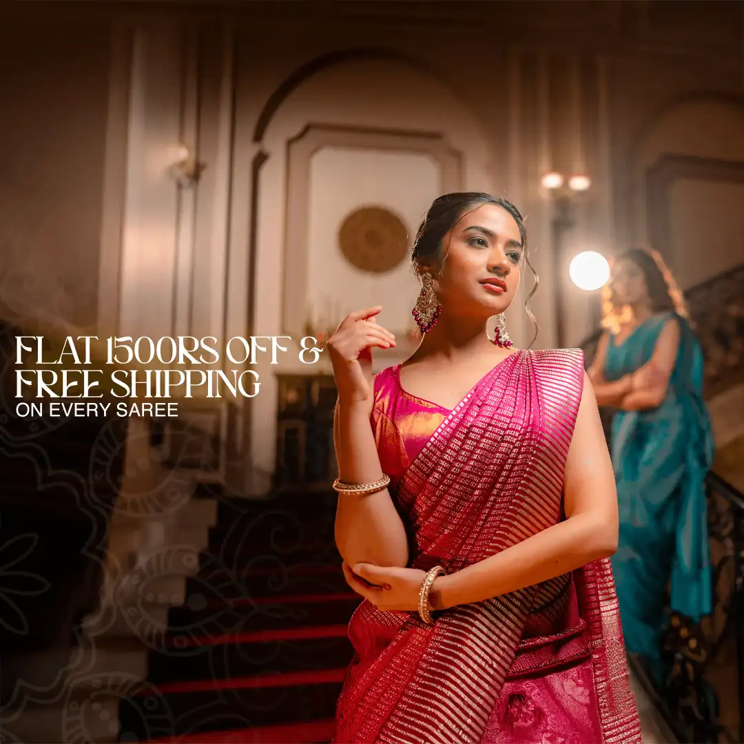 Two women standing together—one wearing a purple crepe silk saree with a pink-red contrast border and zari buttas, and the other wearing a black and white crepe saree—showcasing elegant handcrafted designs from That Saree Shop.