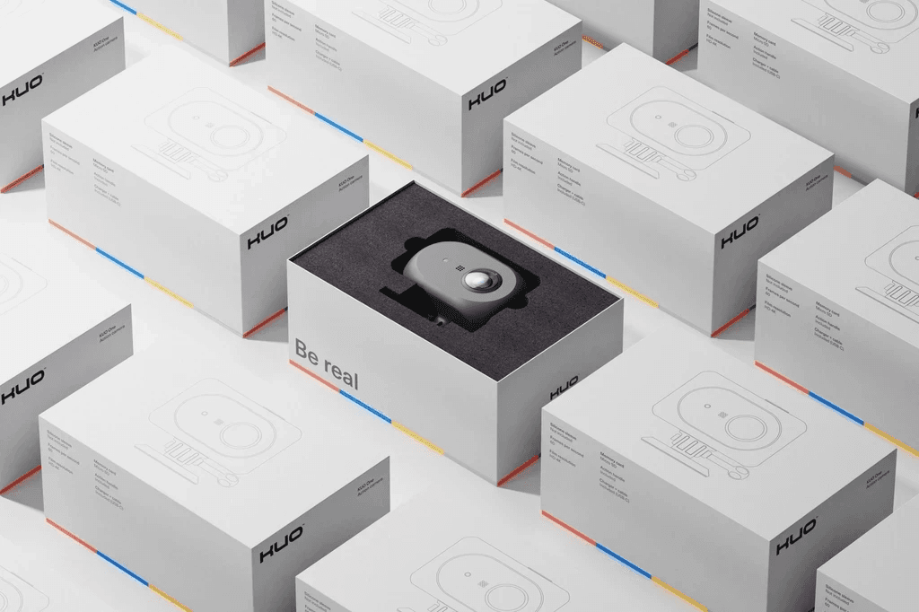 A small black product with a circular control displayed inside a white rectangular packaging box.