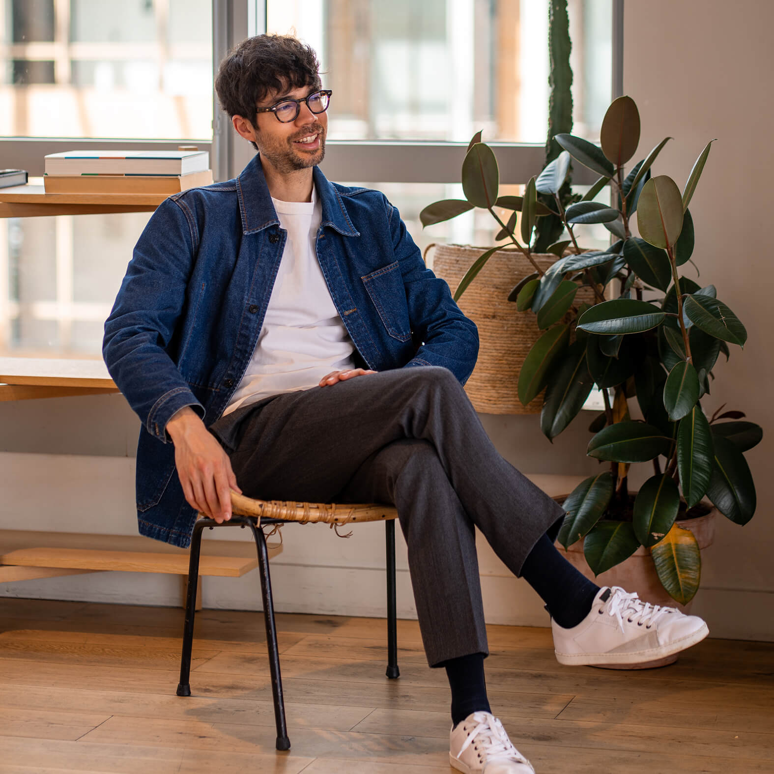 Jean-Charles, the man who made this website, sitting in a chair, smiling