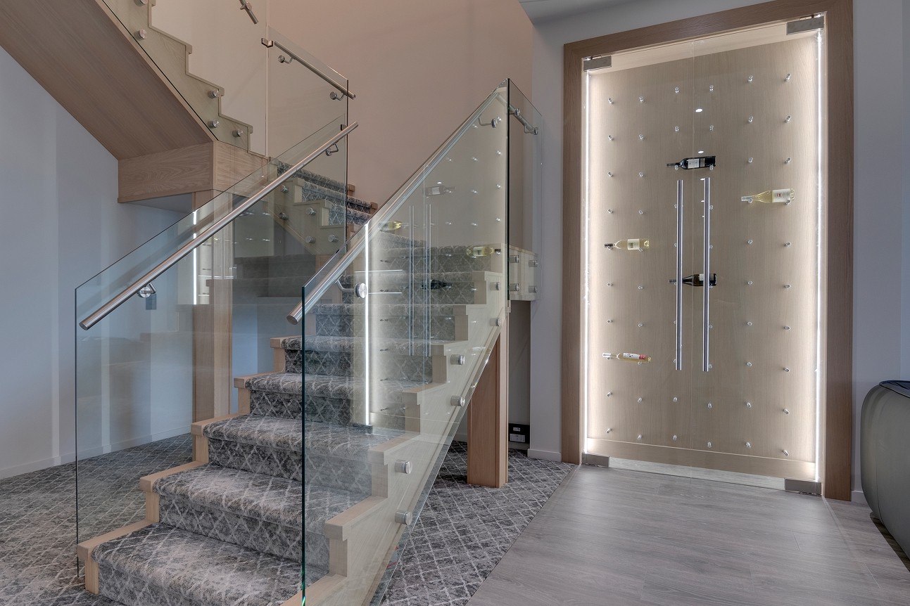 Entryway with floating wood stairs and glass railing