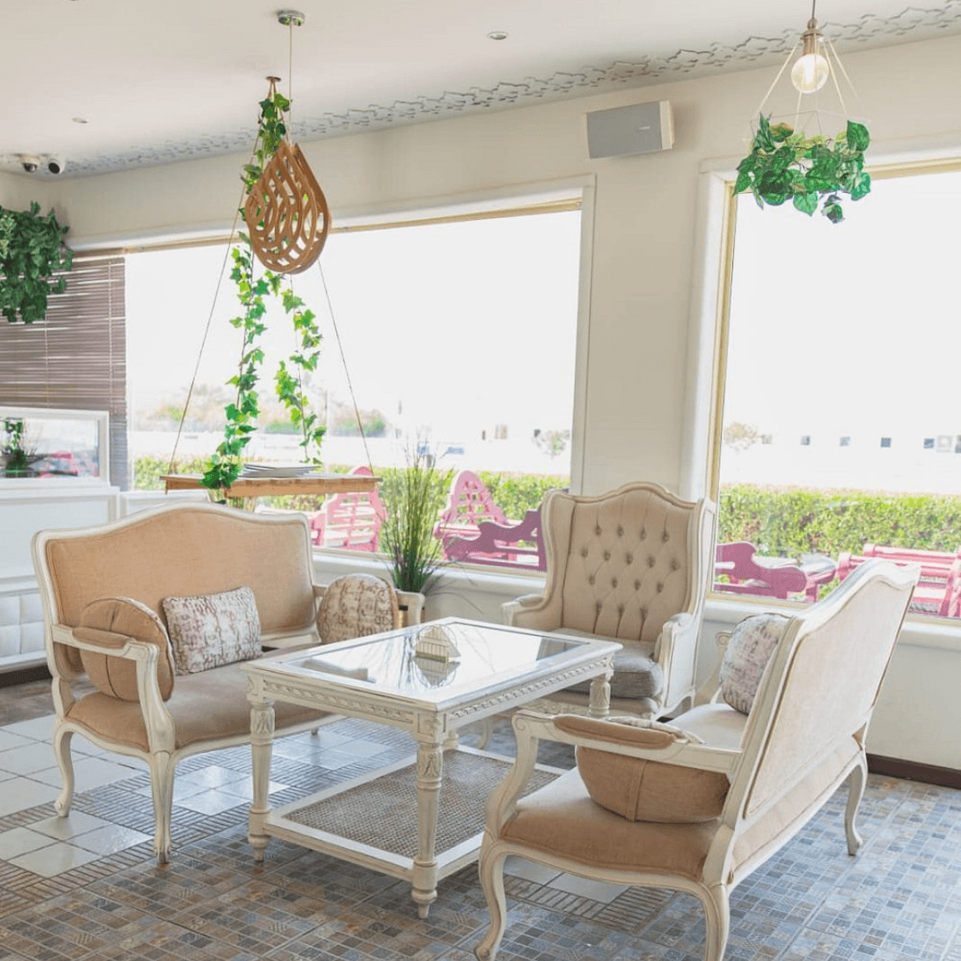 Cosy, sunlit café interior at Café Mandarina, featuring vintage-style sofas.
