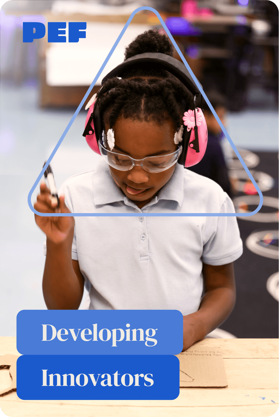 Young, elementary students holding a marker, working on a project in a school fabrication lab.