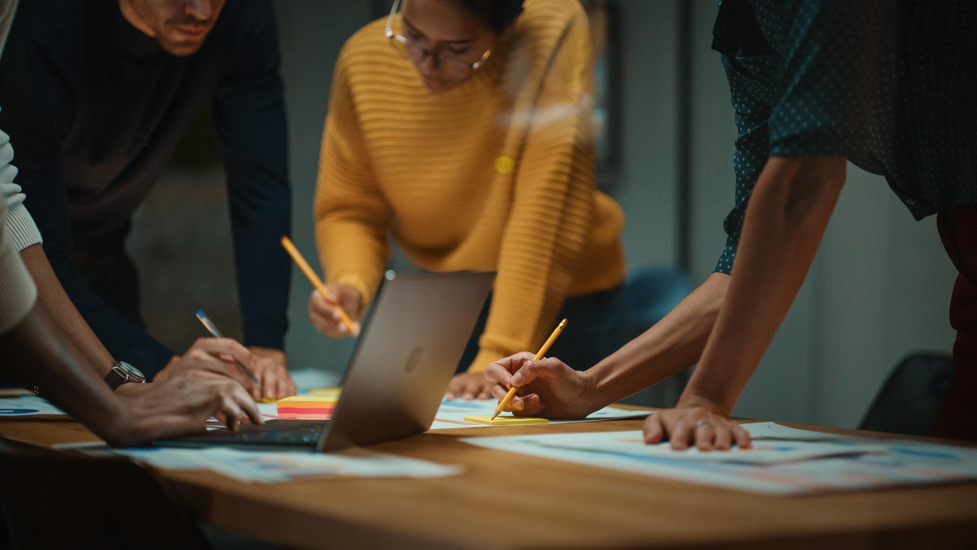Close Up of Diverse Multiethnic Team Having Conversation in Meeting Room in a Creative Office