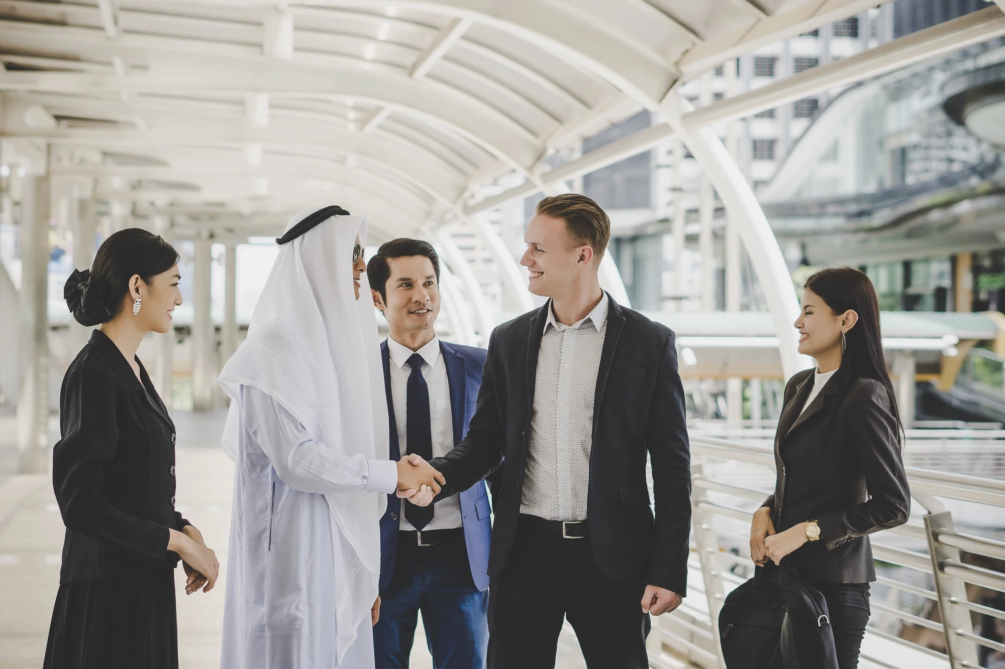 portrait-business-partners-greeting-one-another-by-handshaking-way-office