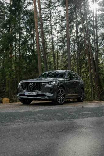 Woman in a beige turtleneck by an old computer and TV, retro 80s office portrait.