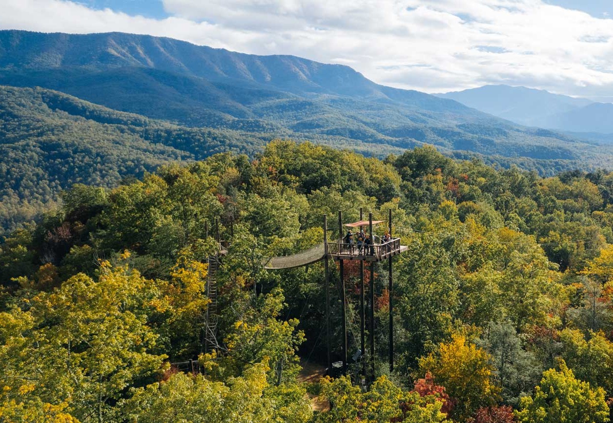 Expansive views of zipline tower against a backdrop of the Great Smoky Mountains