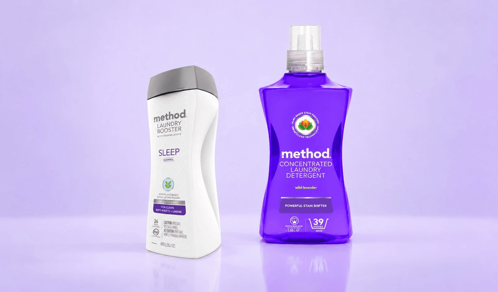 White laundry booster bottle with a purple label beside a purple detergent bottle on a lavender background
