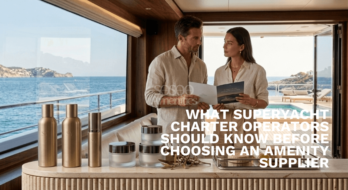 A couple in beige attire reviews a brochure on a luxury yacht. The scene includes elegant toiletries on a counter, with an ocean view and pool outside.