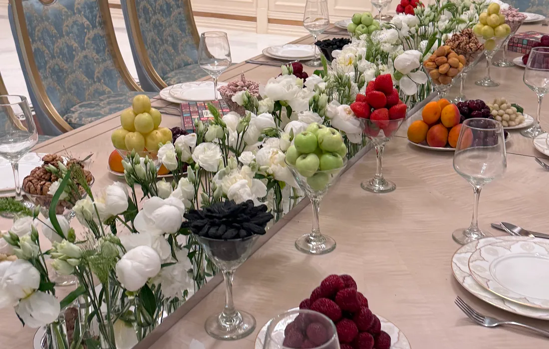 Home wedding setup with elegant table decor, floral centerpiece, and assorted fruits
