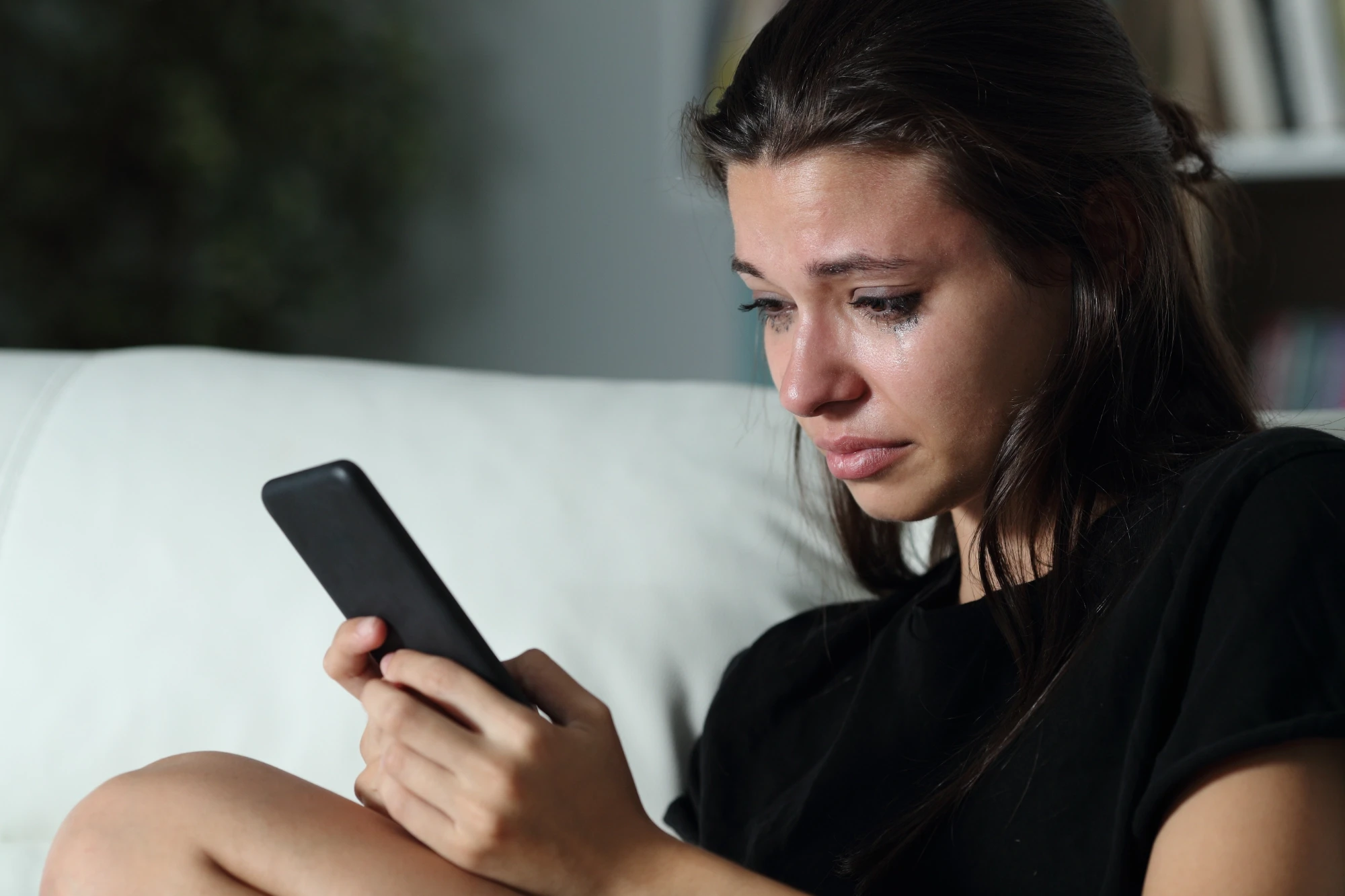 sad girl looking at phone