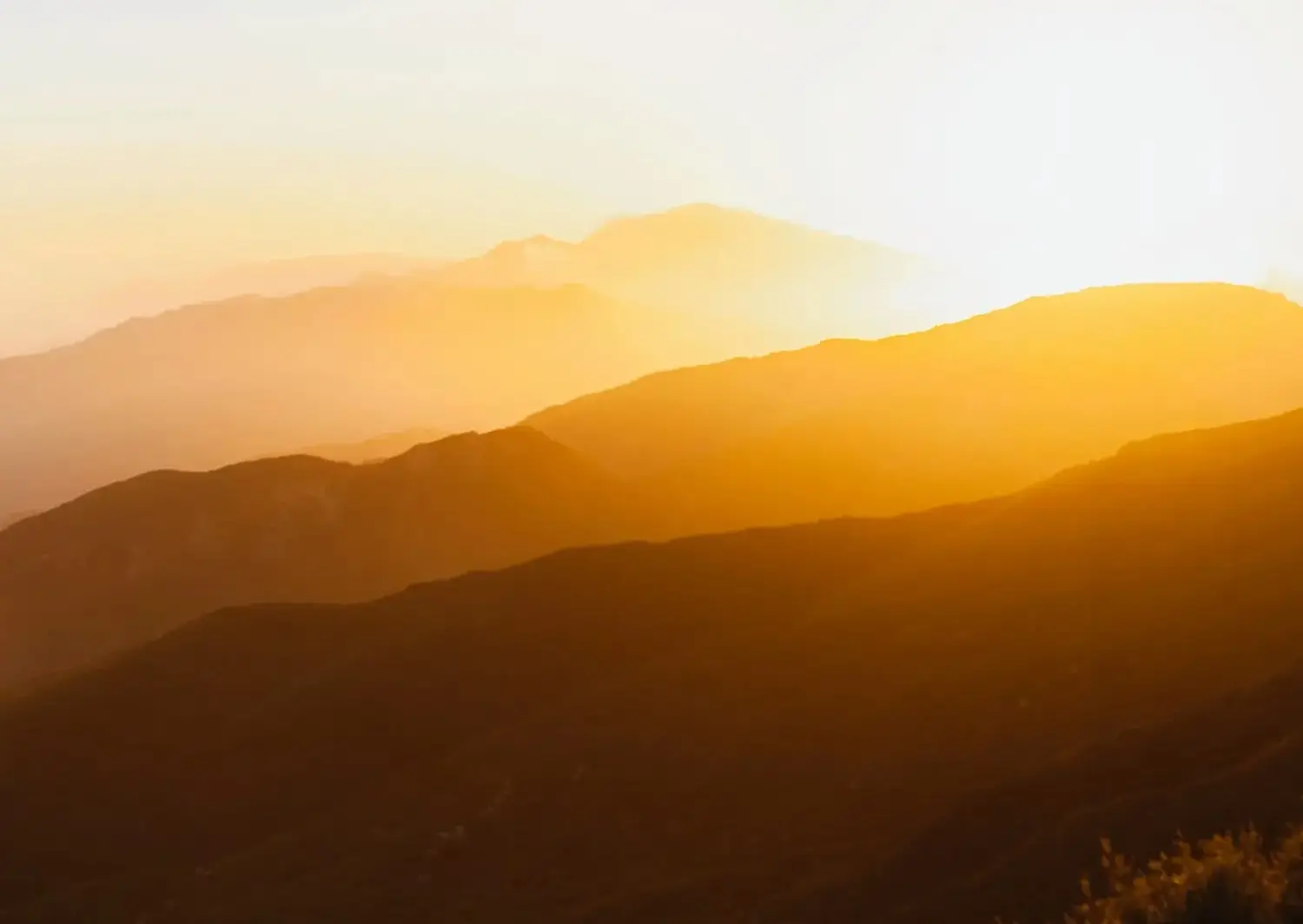 A glowing golden sunset stretches across layered mountain ranges, symbolizing the expansive and transformative journey of spiritually queer relationship therapy. The warm light cascading over the hills reflects themes of healing, emotional depth, and conscious love beyond heteronormative expectations. Just as the mountains unfold in soft gradients, queer relationships invite partners to move beyond rigid right-and-wrong narratives and explore deeper spiritual growth, vulnerability, and authentic connection. This serene landscape mirrors the therapeutic process—creating space for self-examination, releasing old stories, and redefining what love truly means in LGBTQ+ partnerships. The image evokes grounding, reflection, and the sacred opportunity for relational transformation rooted in presence, acceptance, and spiritual awareness.
