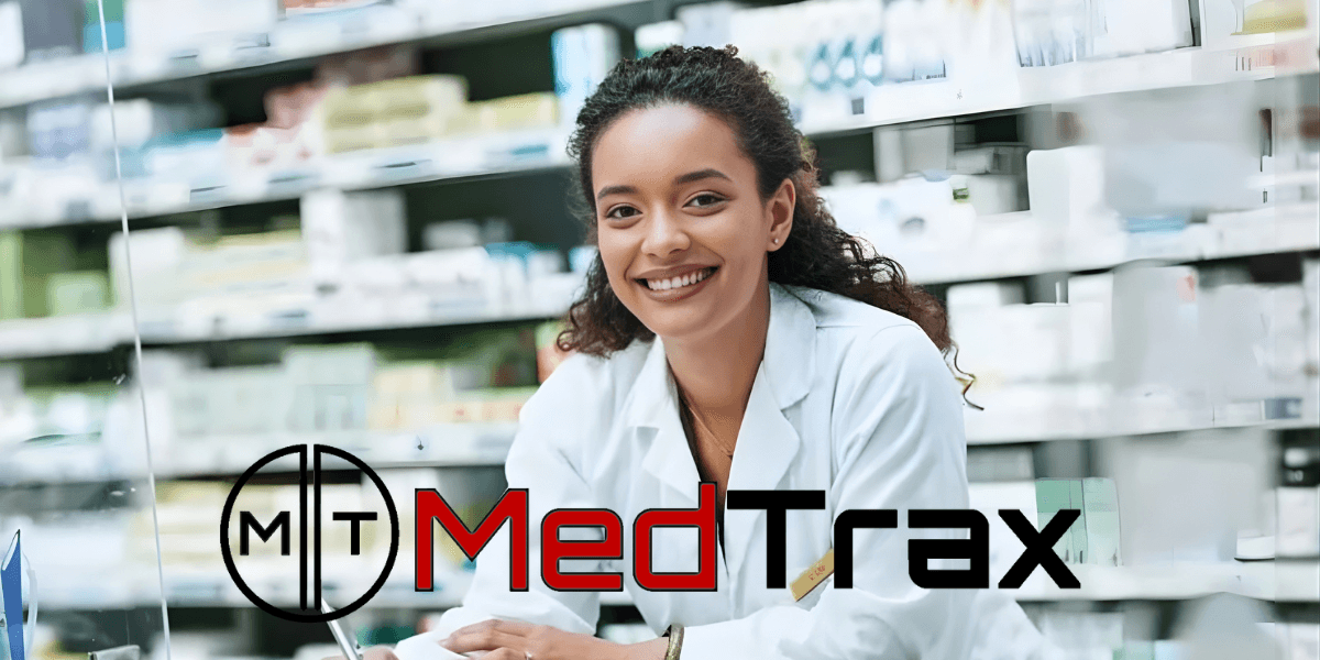 Smiling pharmacist in a white coat at a pharmacy counter with shelves of medications, MedTrax logo overlayed.