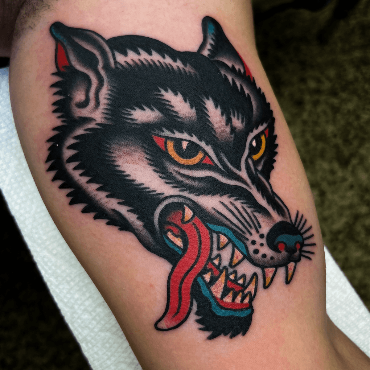 color tattoo of a wolf head