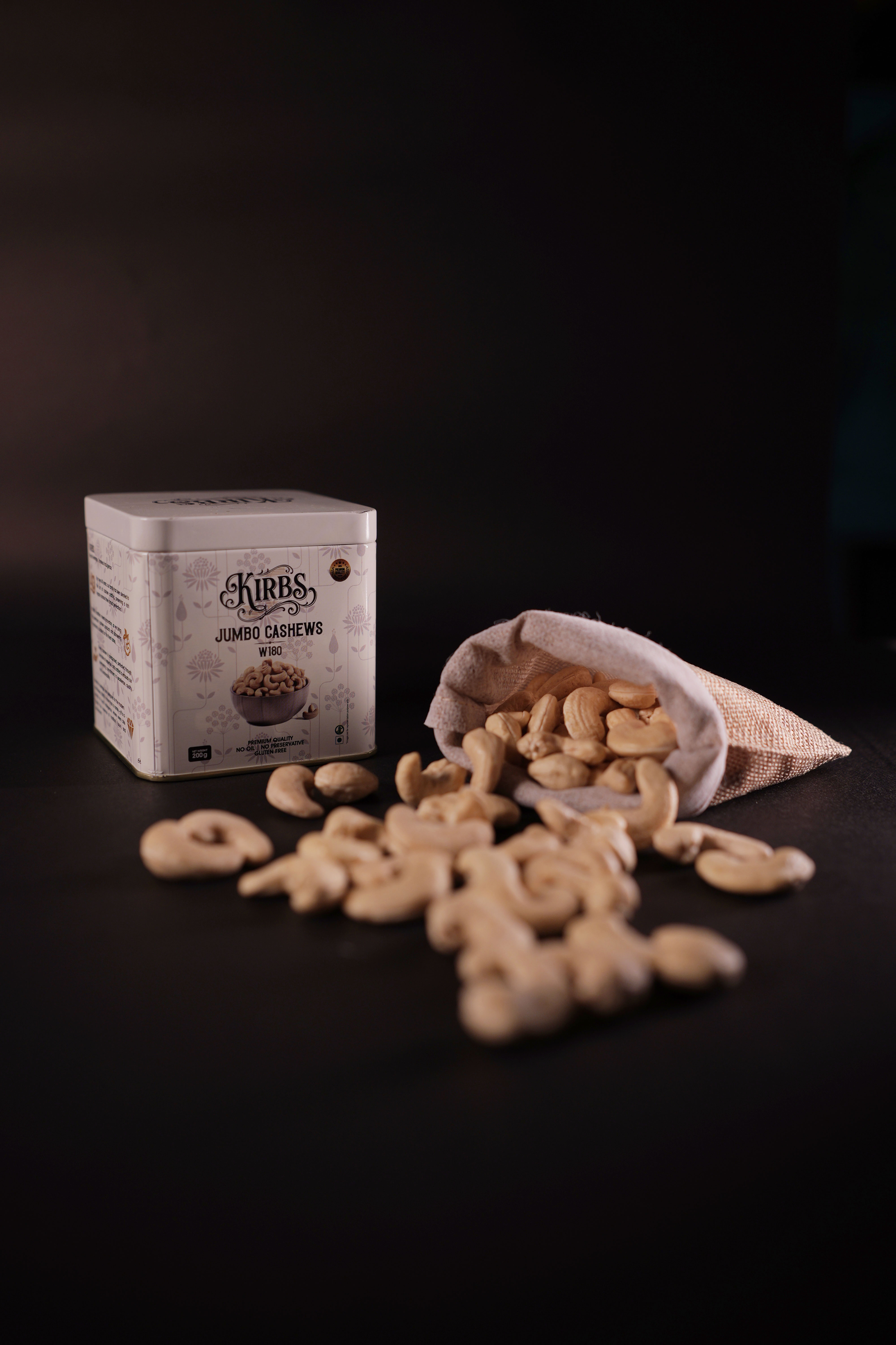 a pink bowl filled with cashews on top of a yellow table