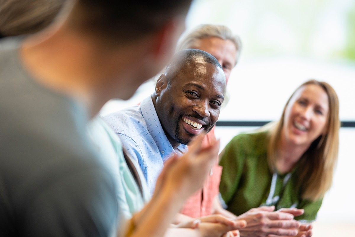 Diverse group of colleagues smiling and chatting