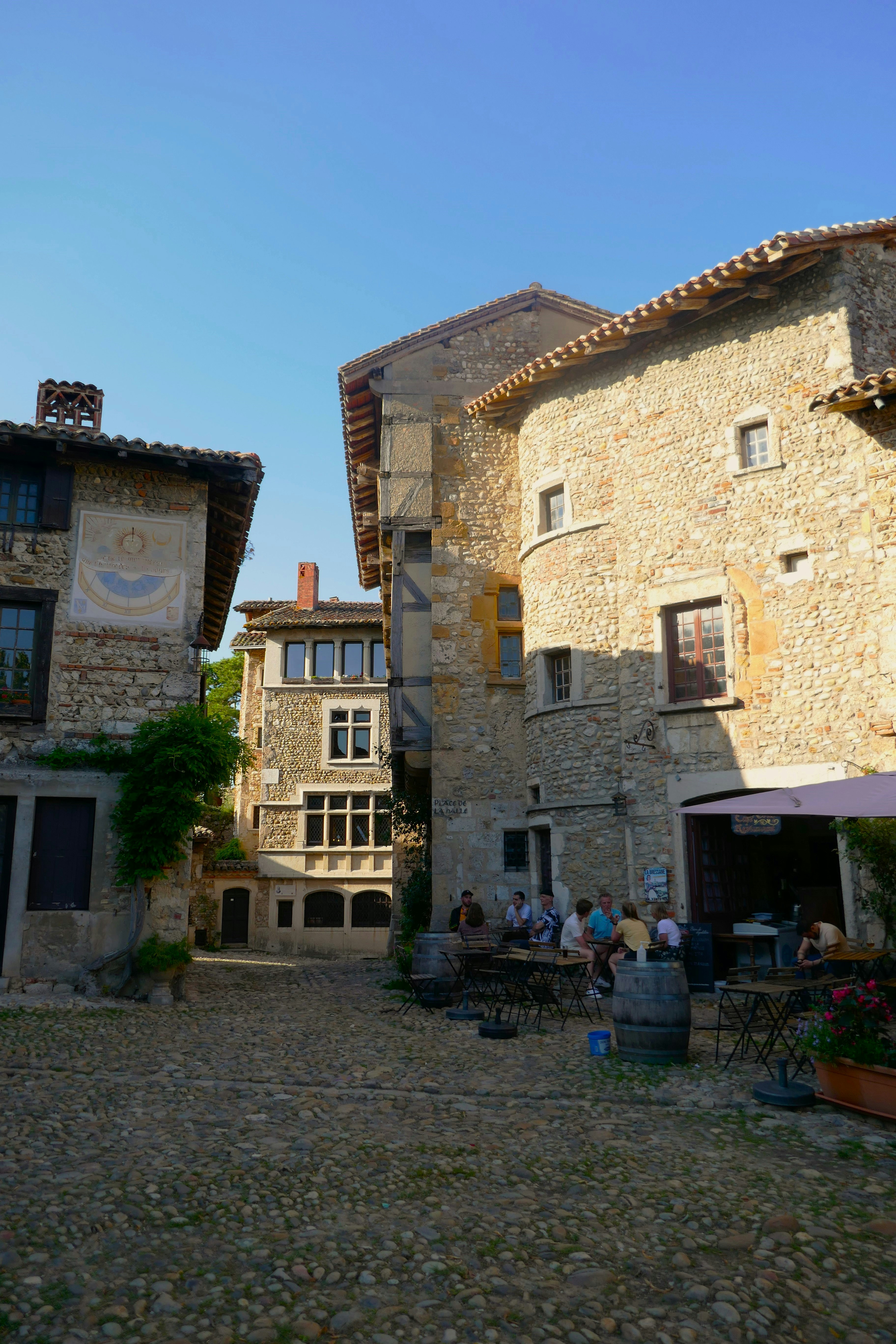 A group of people sitting outside of a building