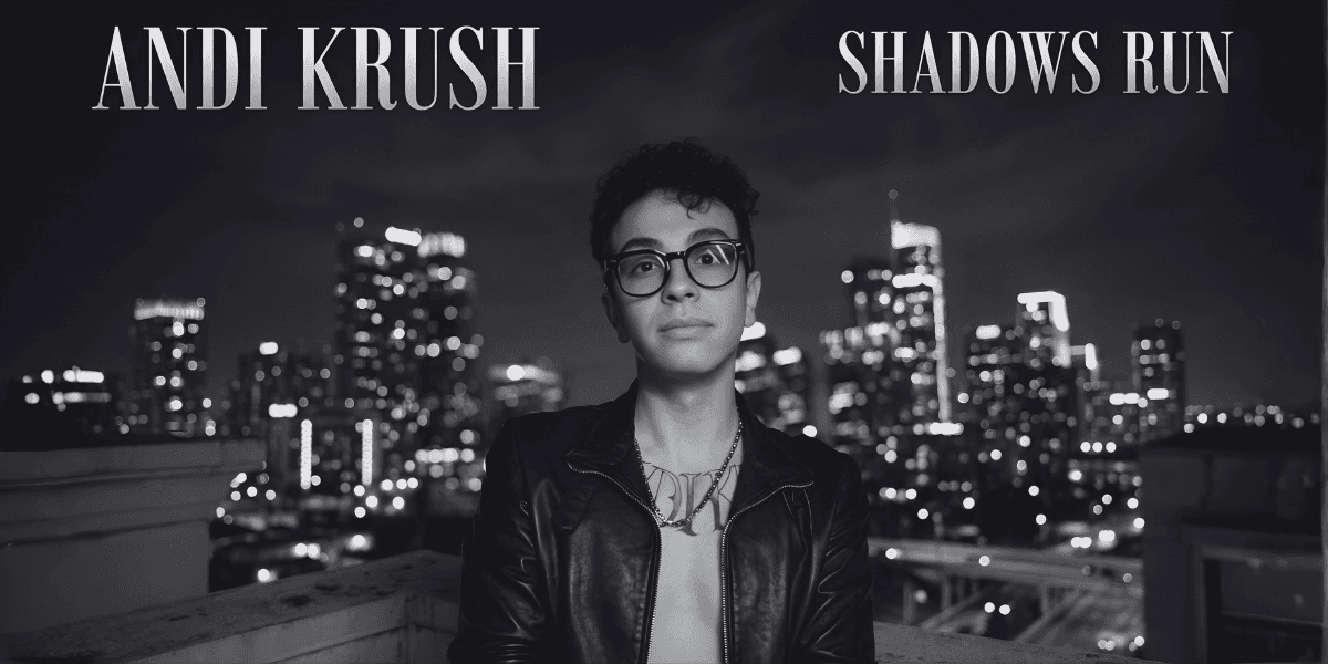 Black-and-white portrait of artist on rooftop with city skyline; text “Andi Krush” and “Shadows Run.”
