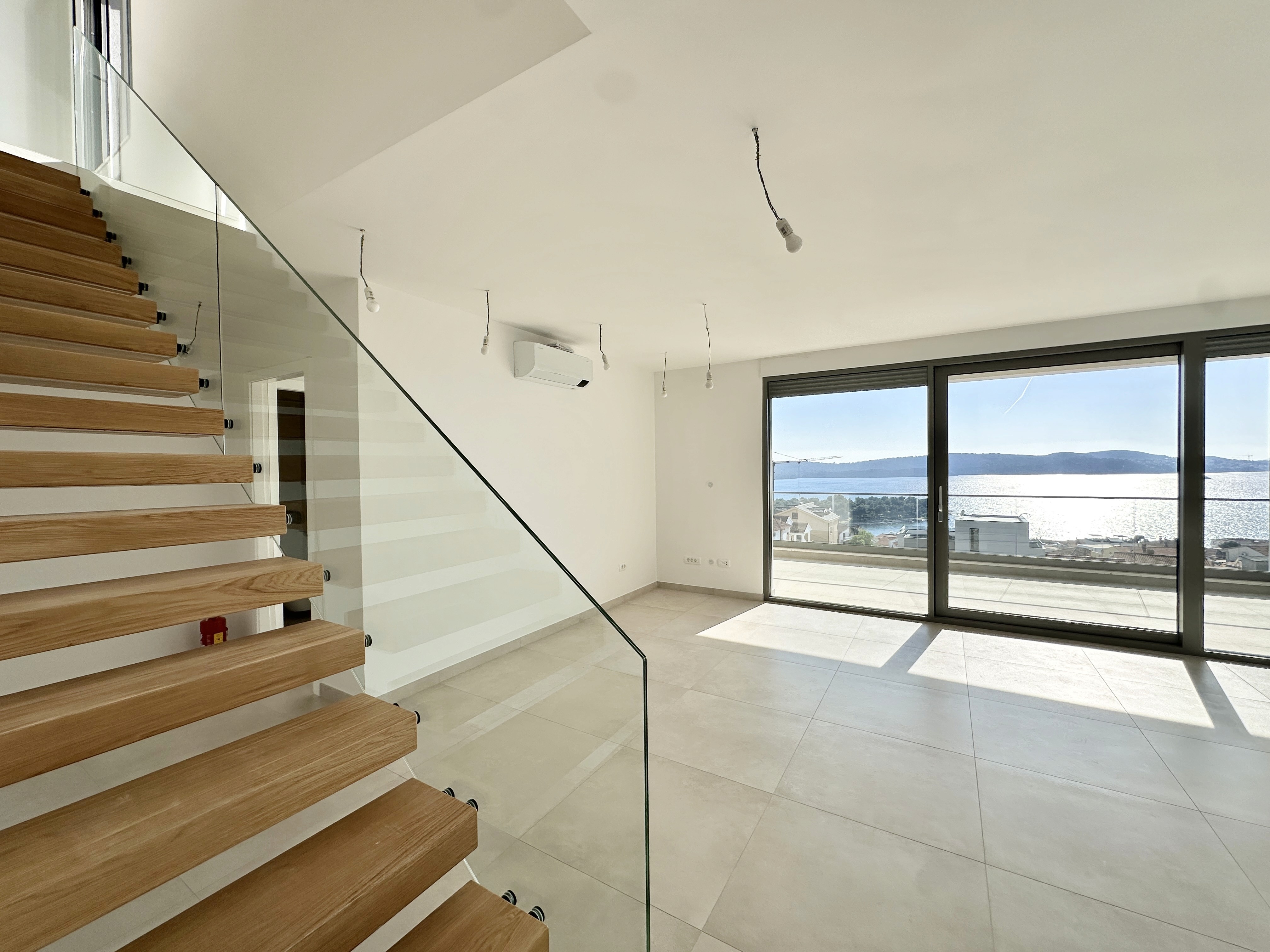 Bedroom with wall bookshelf and mountain view.