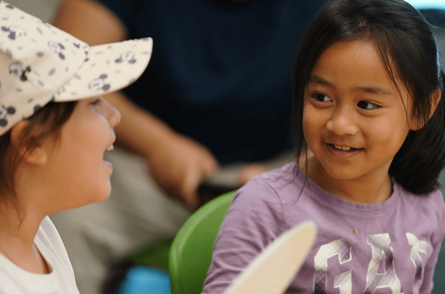 Students sharing a supportive moment during HOKALI aftercare, fostering belonging and emotional well-being.