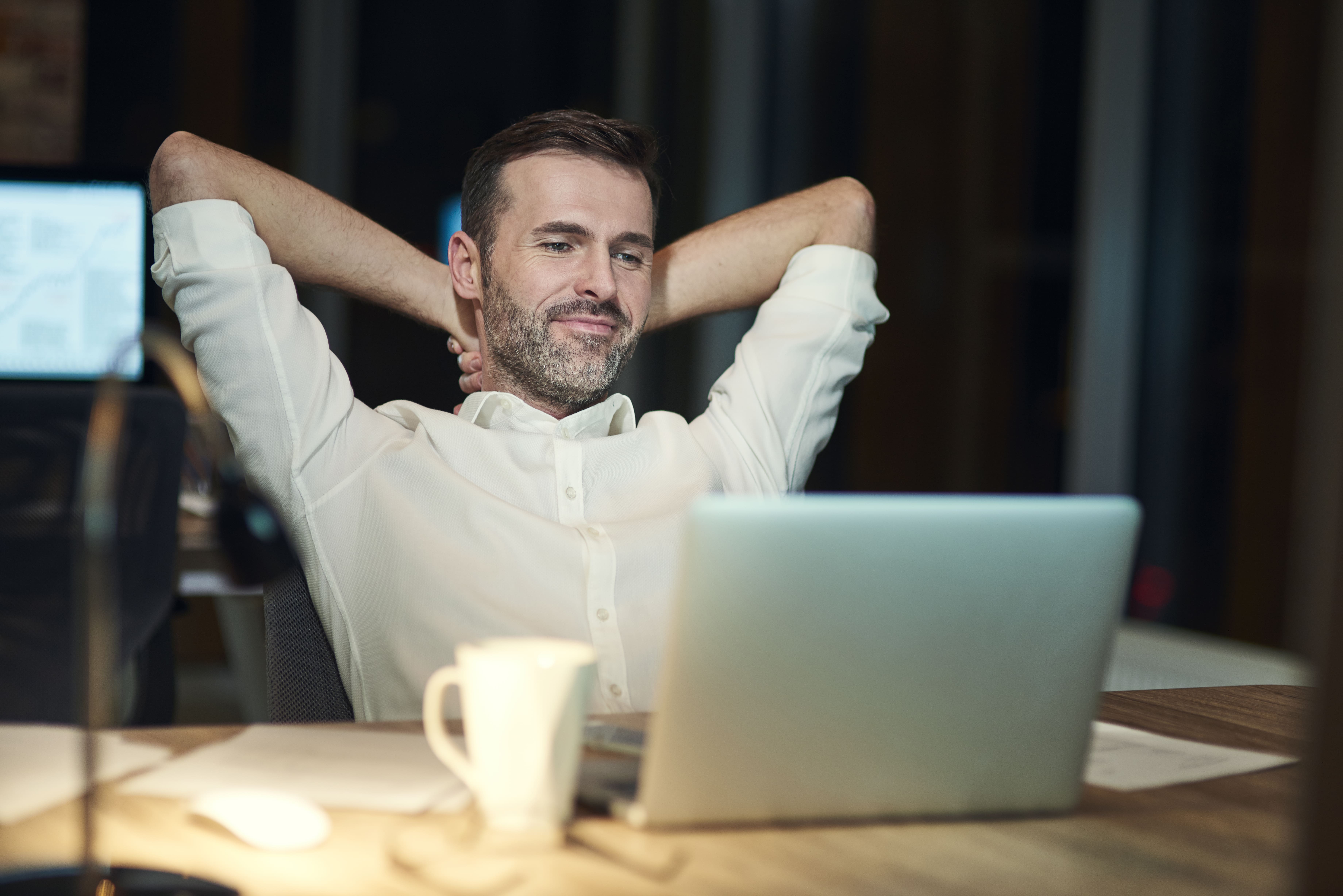 Satisfied man resting in his office