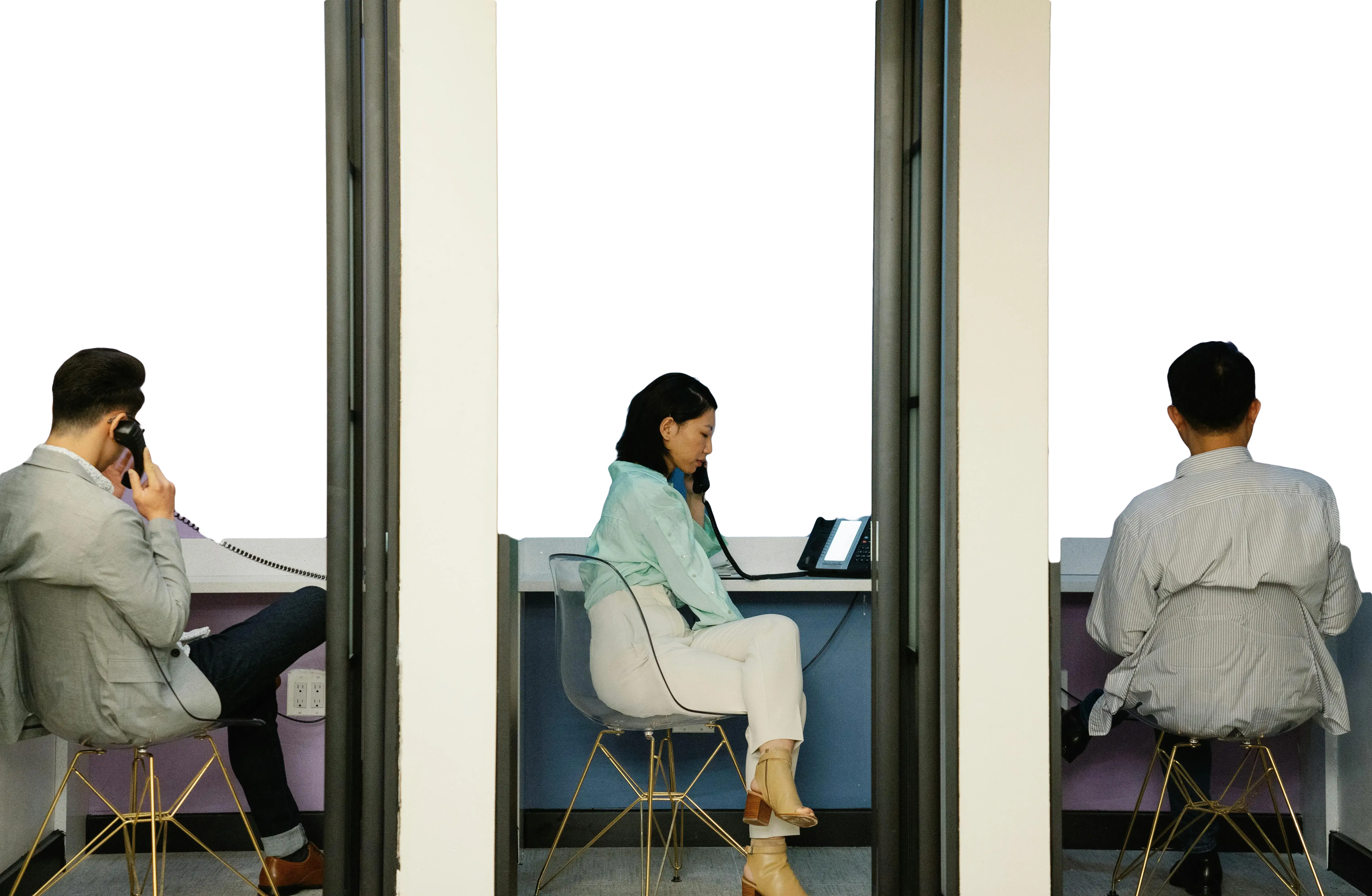 Two people sit in separate office booths while on phone calls