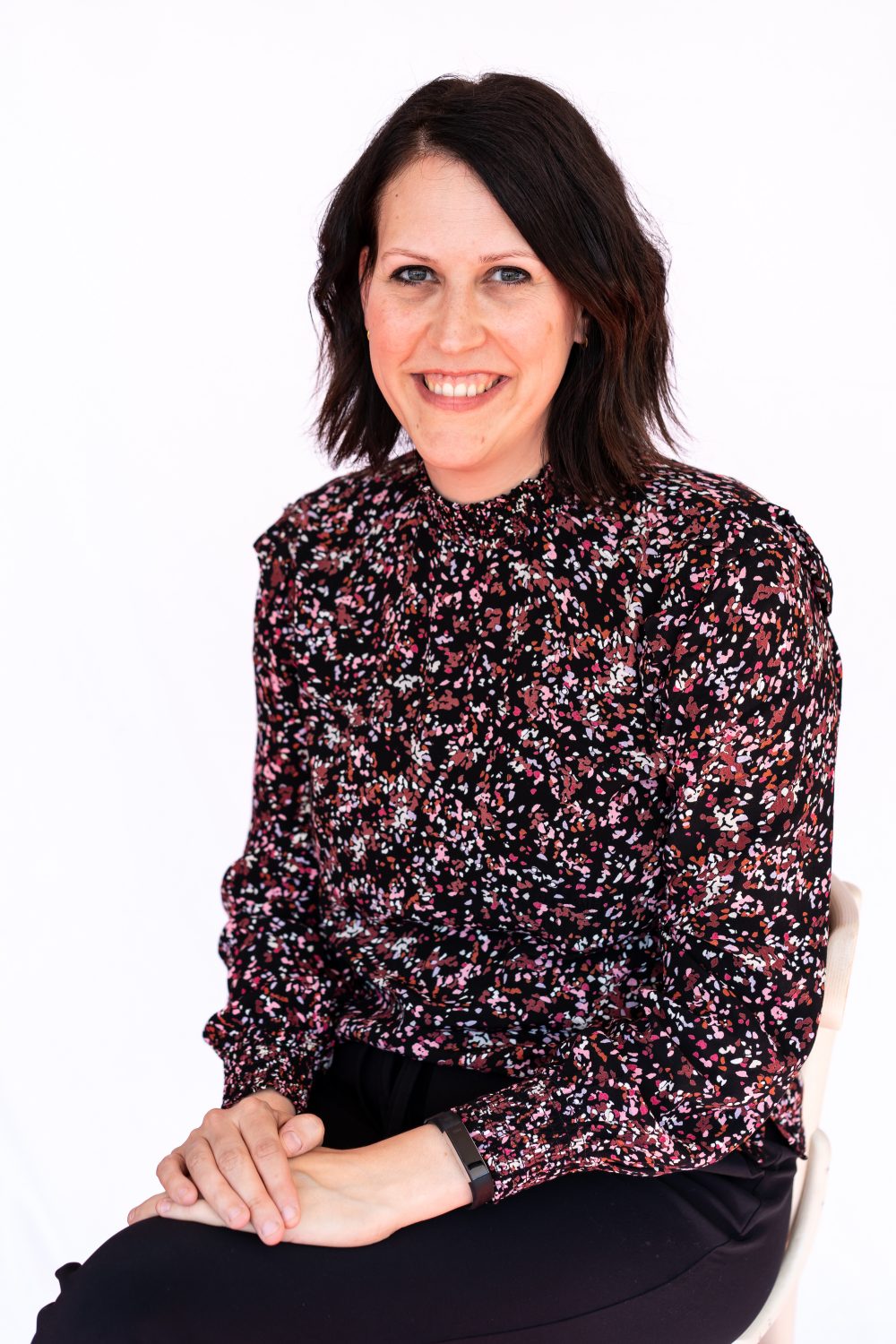 woman in black blazer smiling