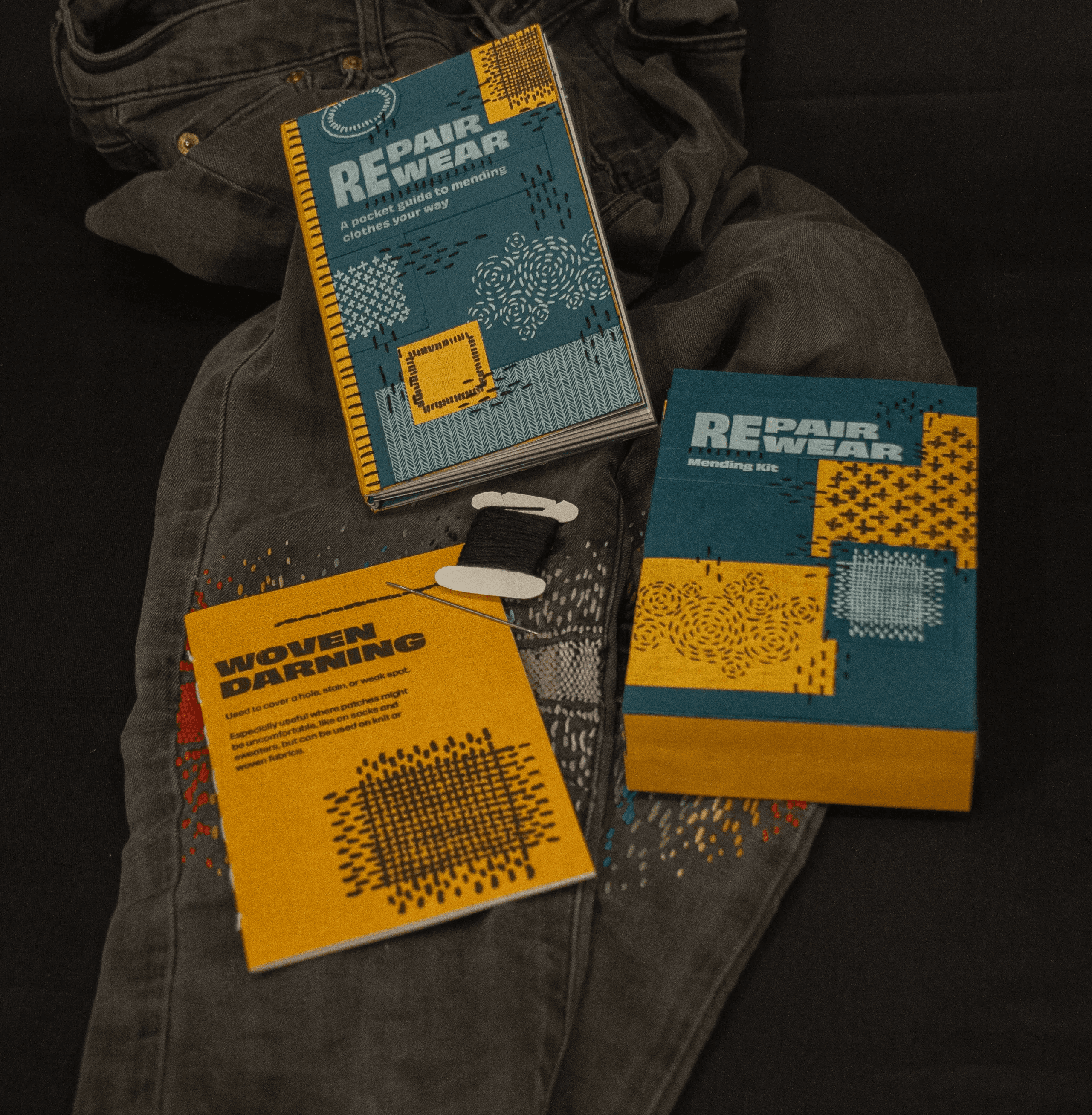 Mending guide and kit on top of mended jeans