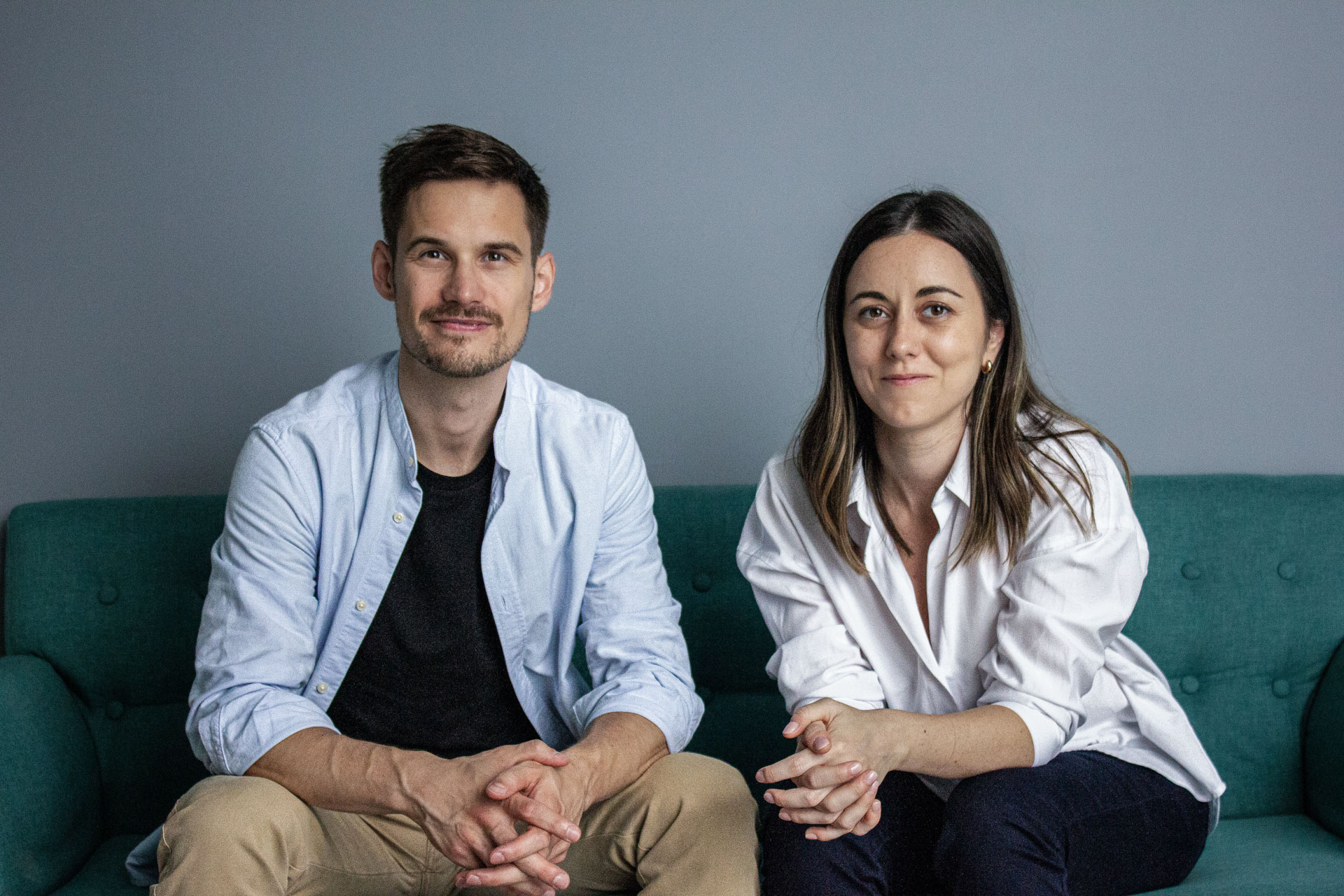 he two founders of Tilebox sitting on a couch, smiling at the camera.